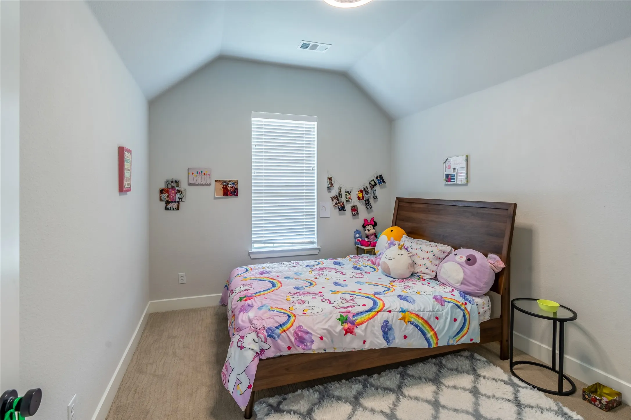 Bedroom with carpet flooring and lofted ceiling