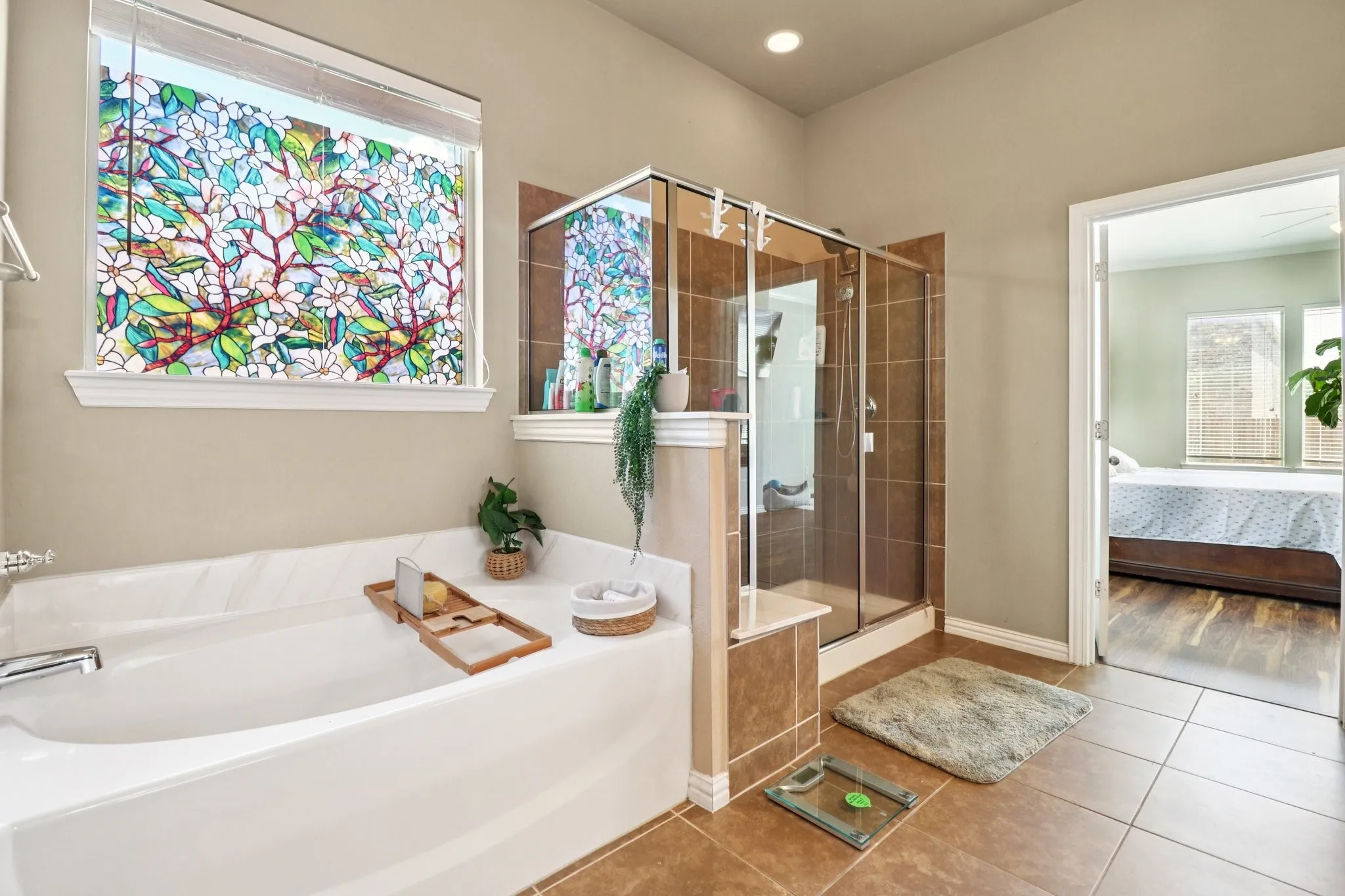 Bathroom featuring connected bathroom, a bath, tile patterned flooring, and a shower stall