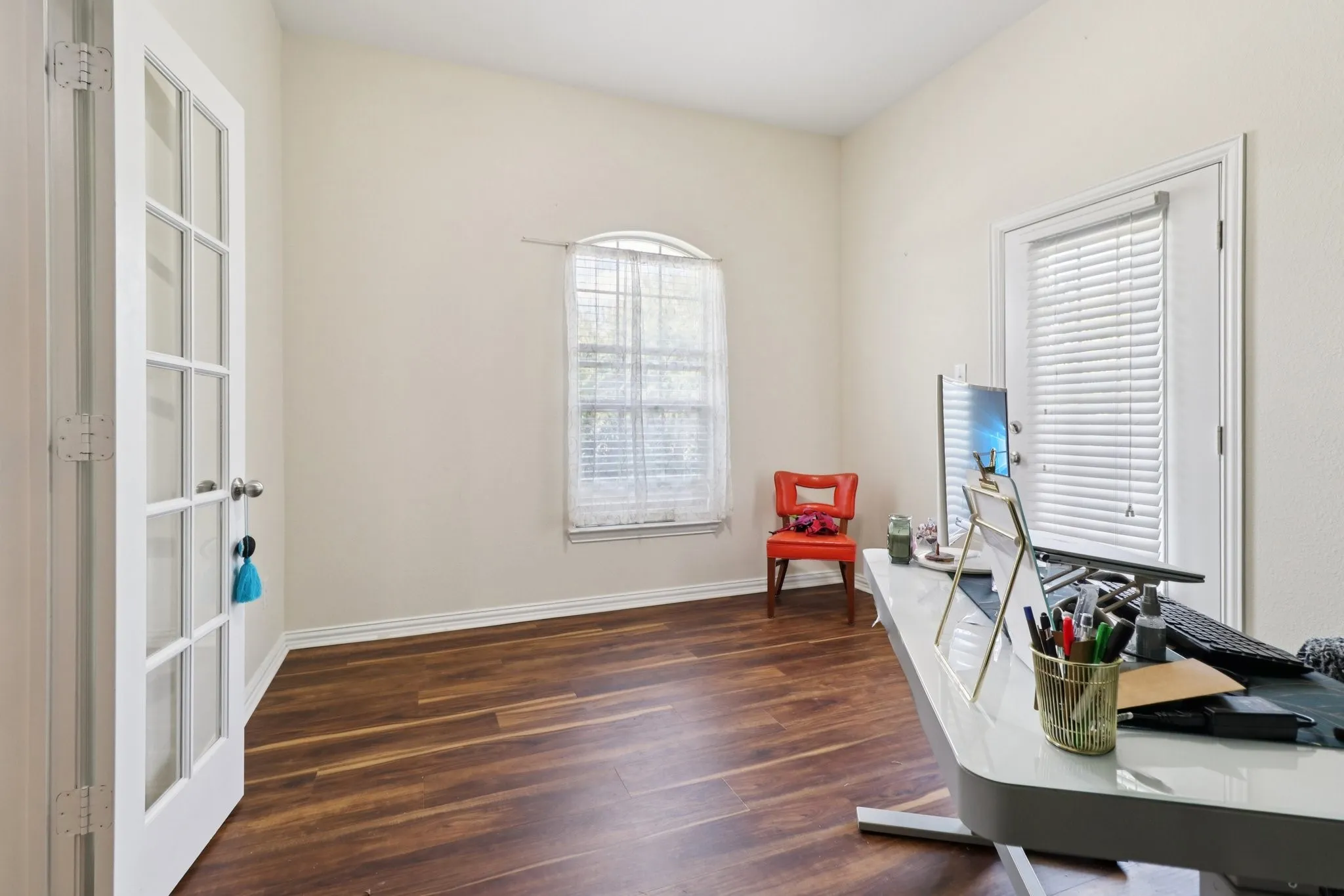 Office space featuring baseboards and dark wood-type flooring