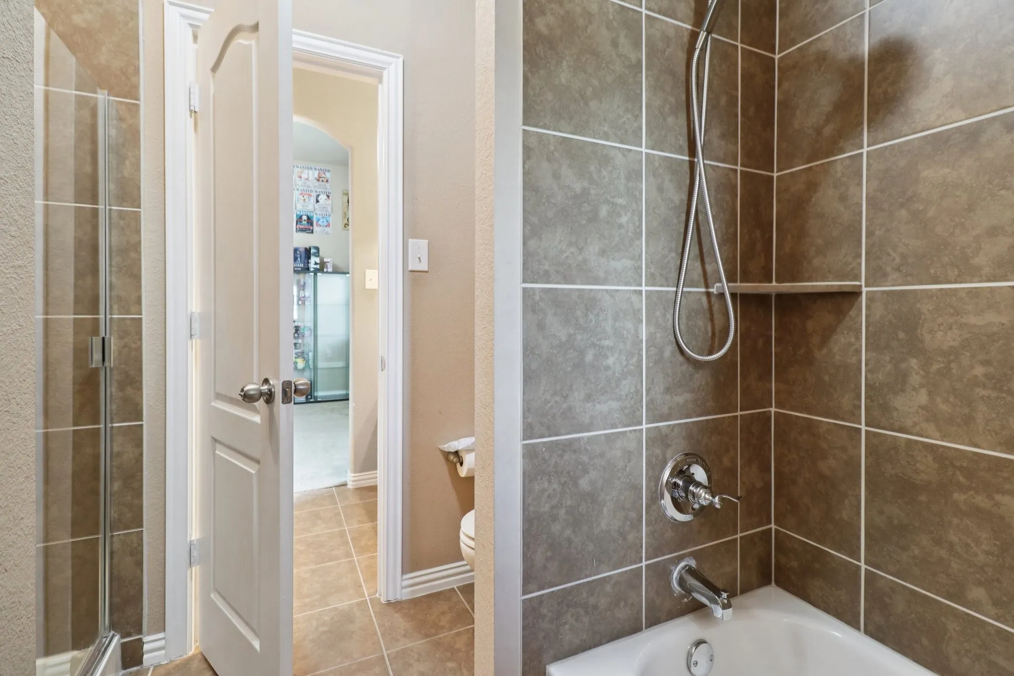 Full bathroom with shower / tub combination and light tile patterned flooring