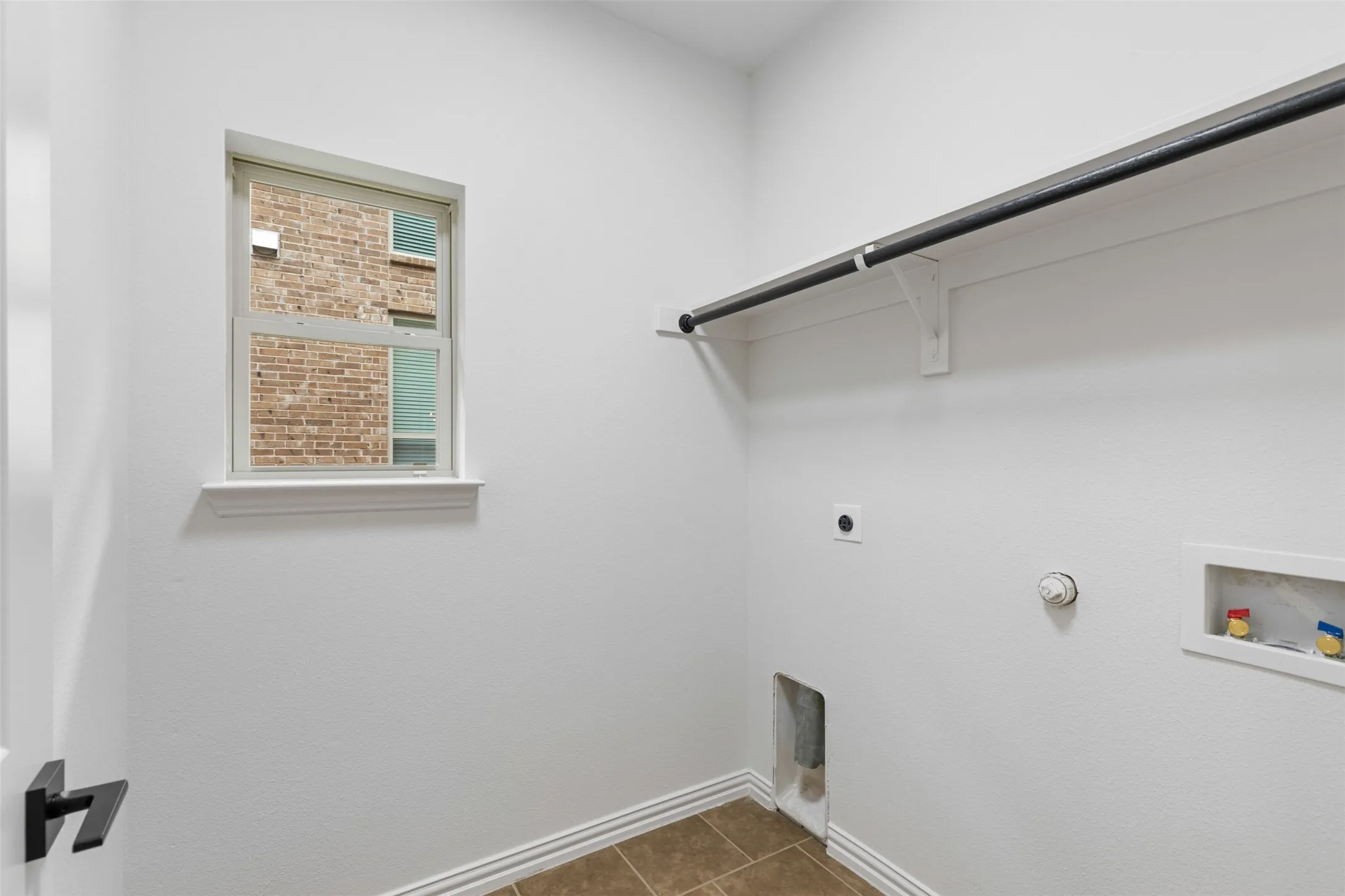 Laundry room featuring hookup for a gas dryer, washer hookup, laundry area, electric dryer hookup, and baseboards