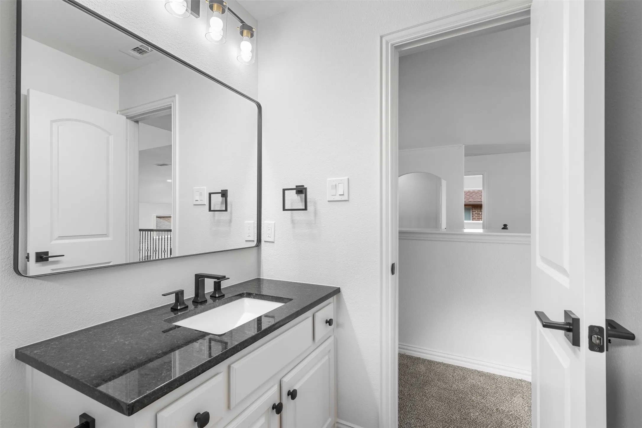 Bathroom featuring visible vents and vanity