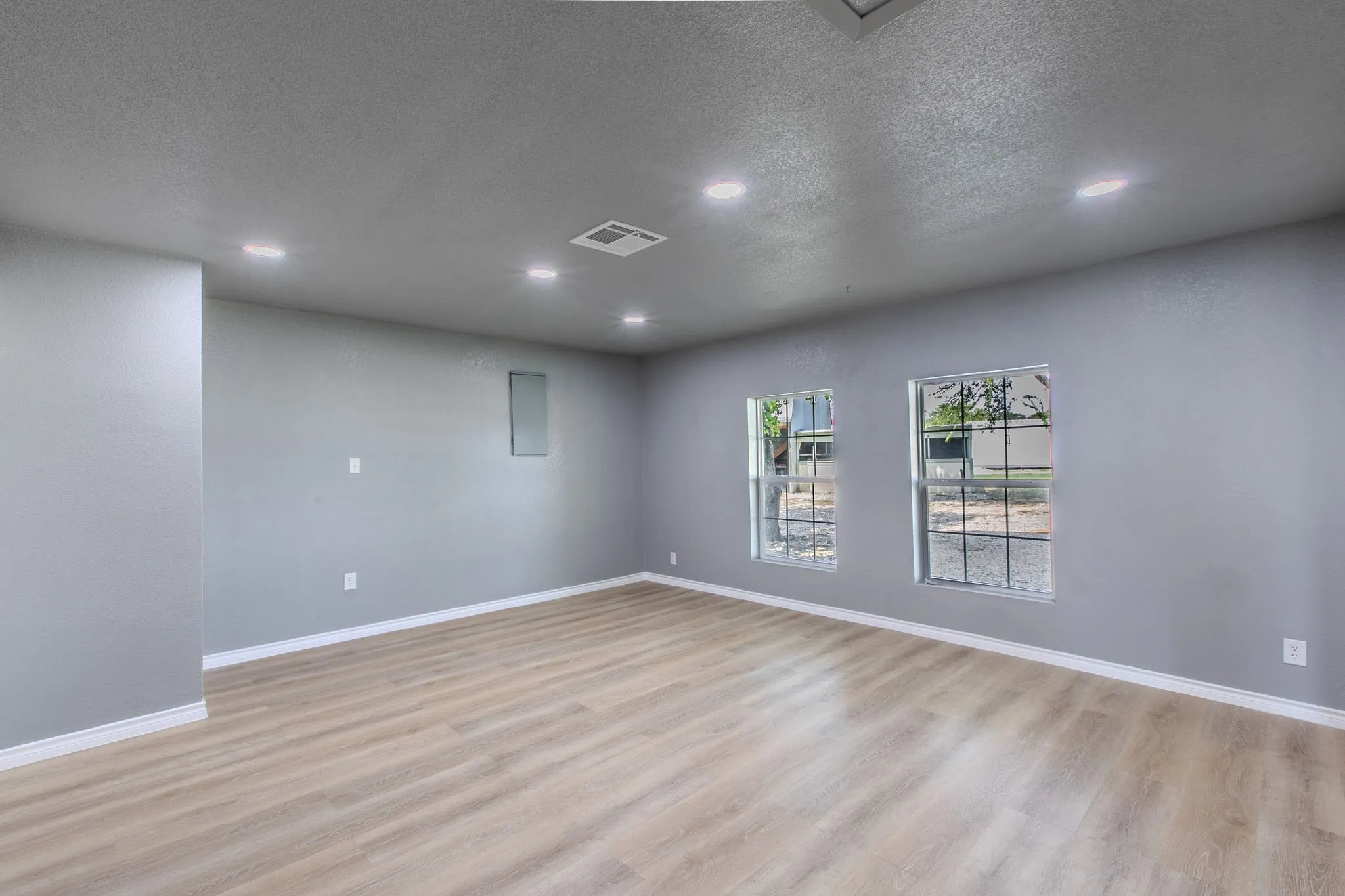 Spare room featuring a textured ceiling, light wood-style flooring, and recessed lighting