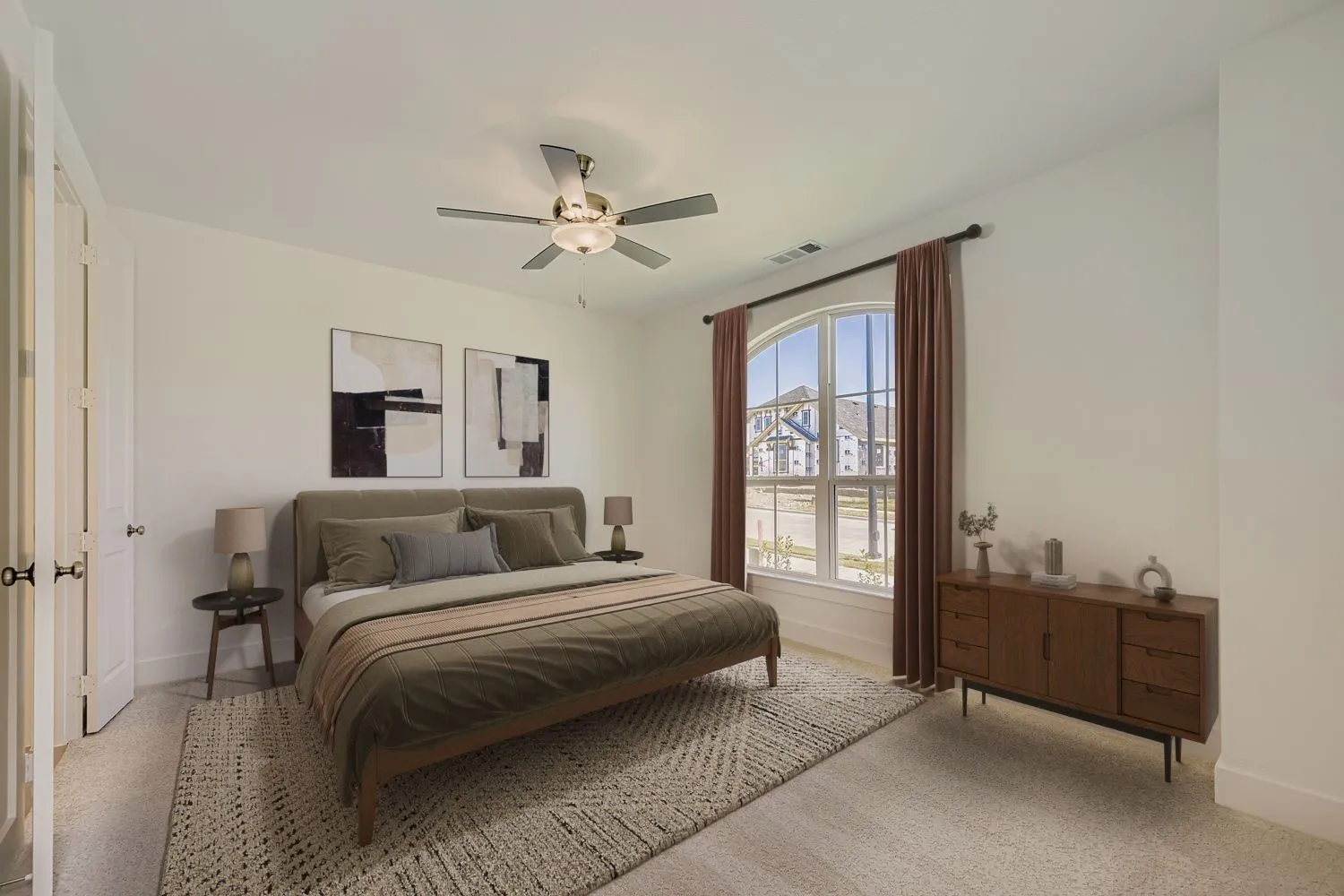 Virtually staged photo - Carpeted room featuring an arched window, ceiling fan, and white paneled doors