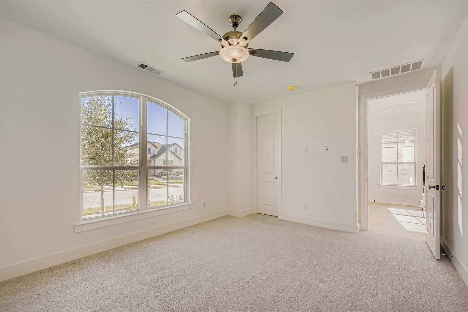 Unfurnished bedroom featuring light colored carpet and ceiling fan