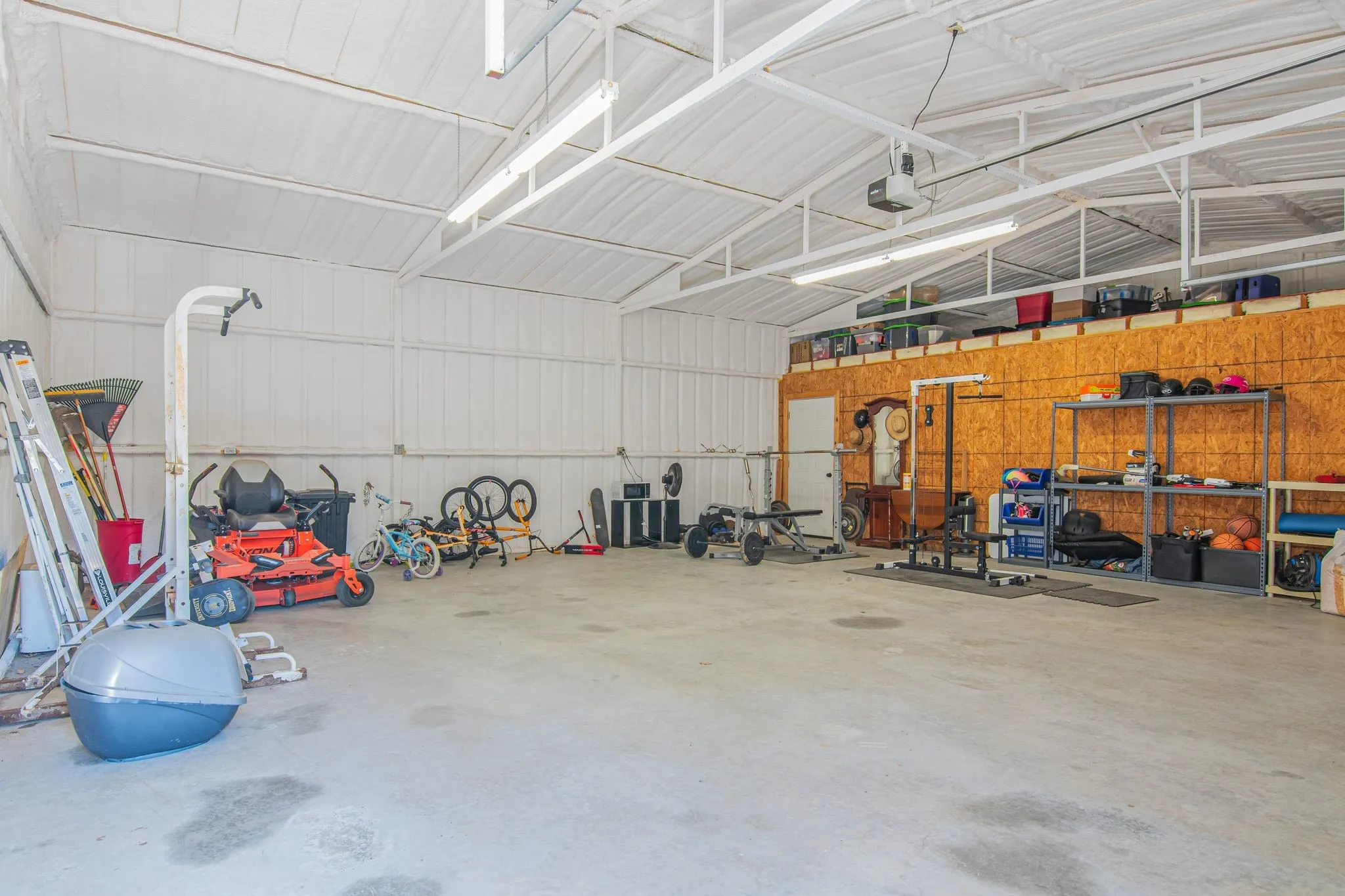 Inside large garage/workshop featuring concrete floor and electricity