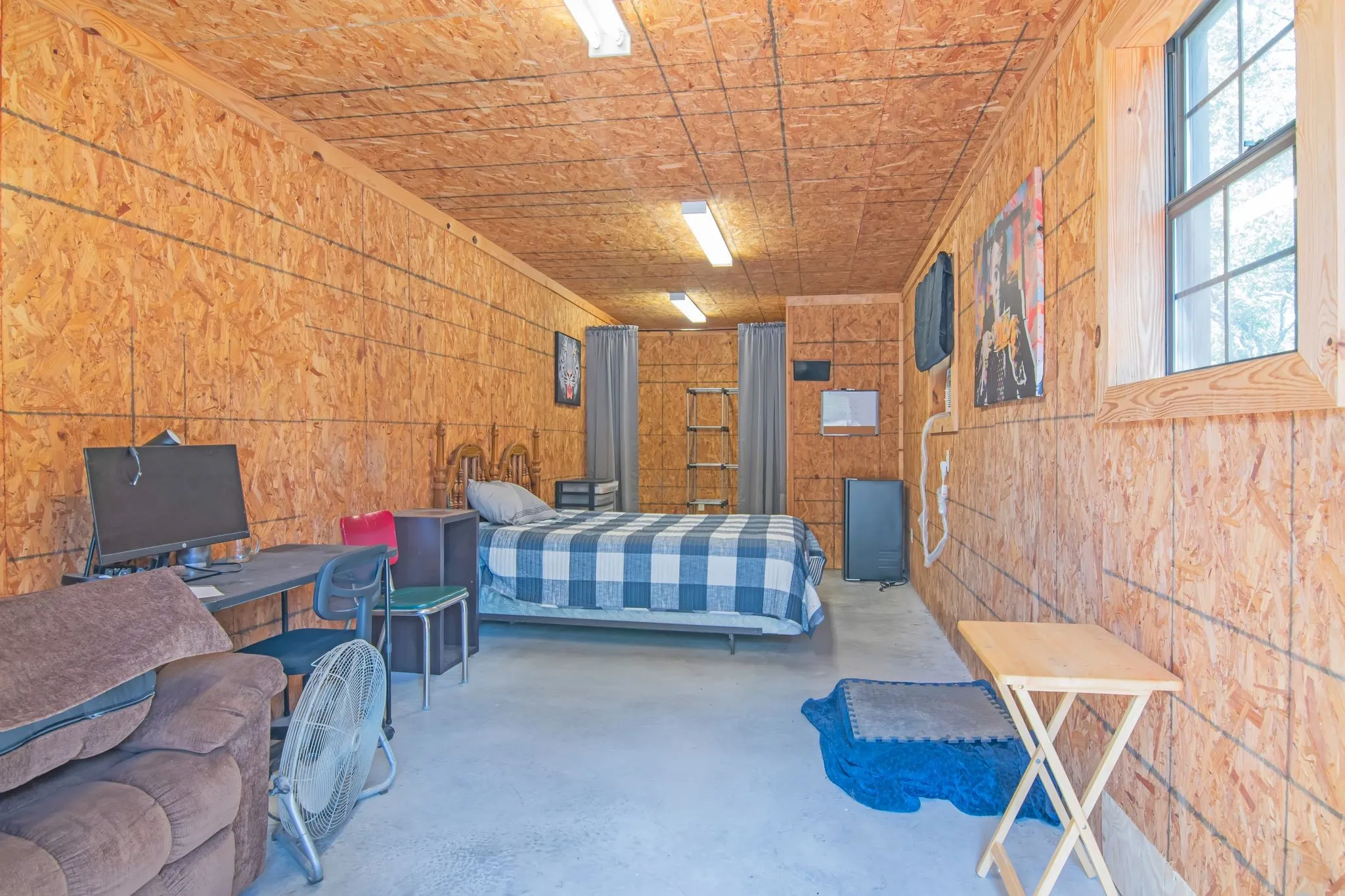 Unfinished potential for guest space or craftroom inside garage/workshop with electric. Water is plumbed to the building.