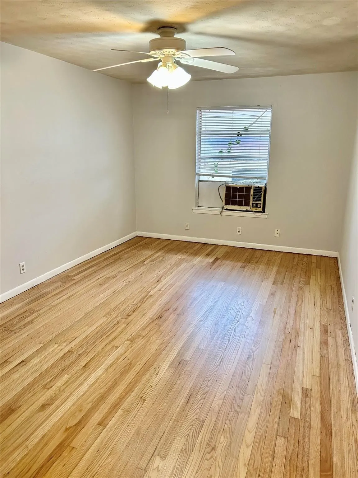 Unfurnished room with light wood-style flooring and ceiling fan