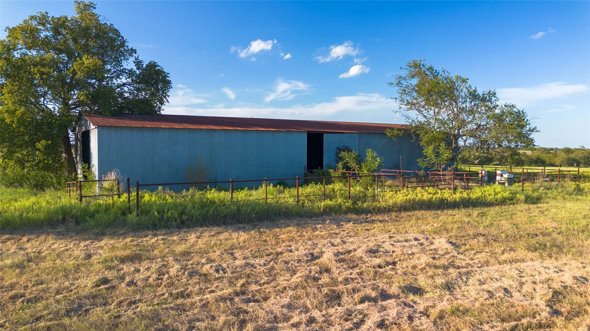 View of side of property featuring an outdoor structure and a pole building