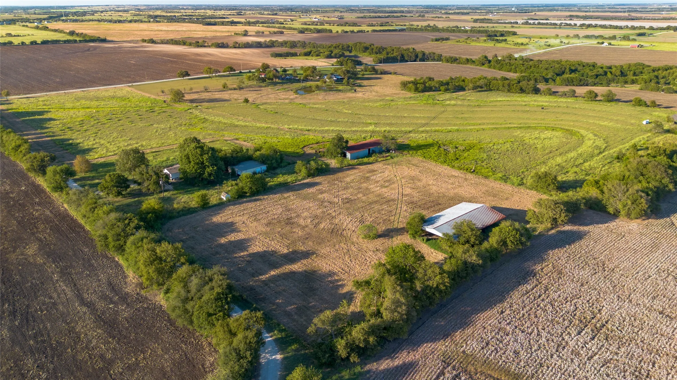 Aerial view of sparsely populated area with large plots for crops