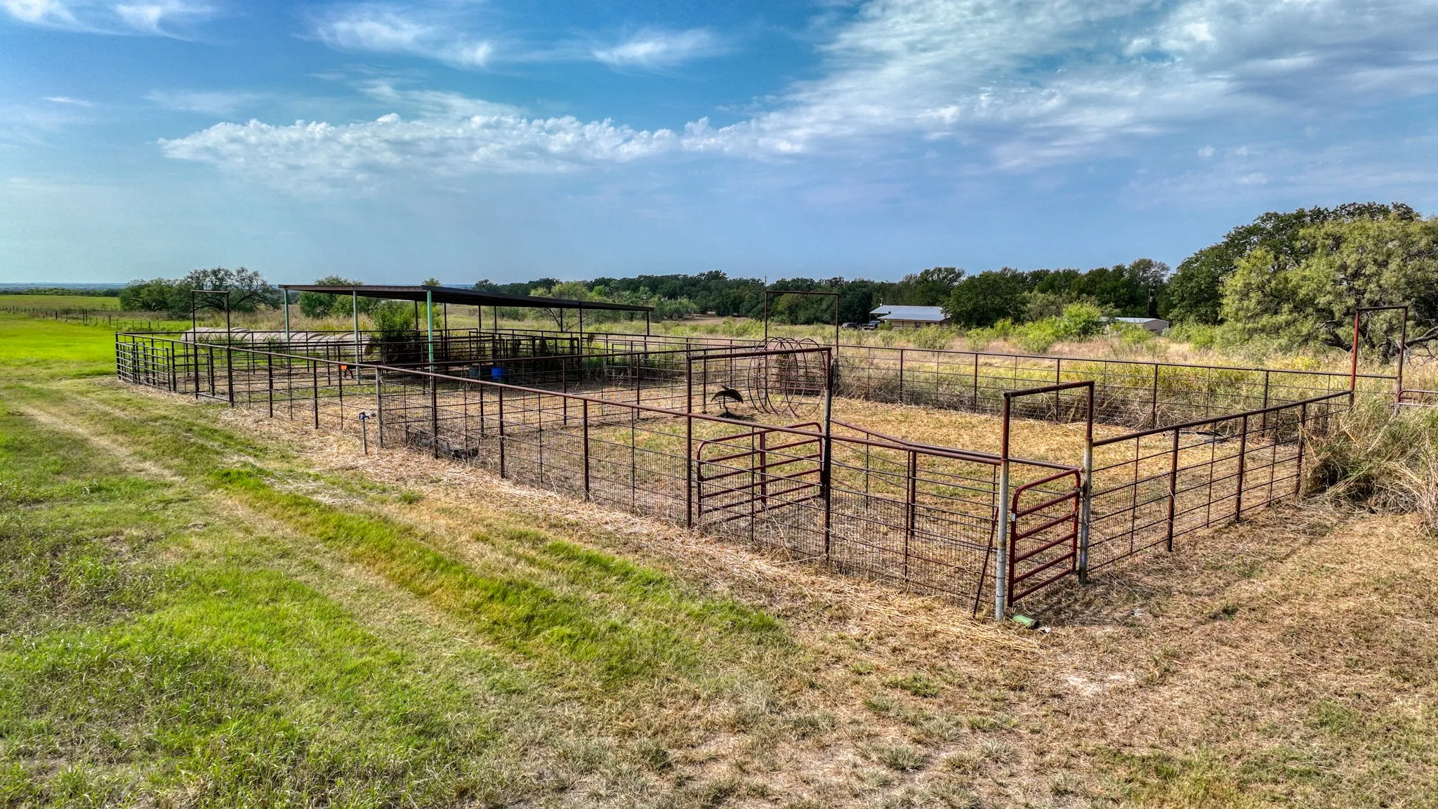 View of yard featuring a rural view, an exterior structure, and an outdoor structure