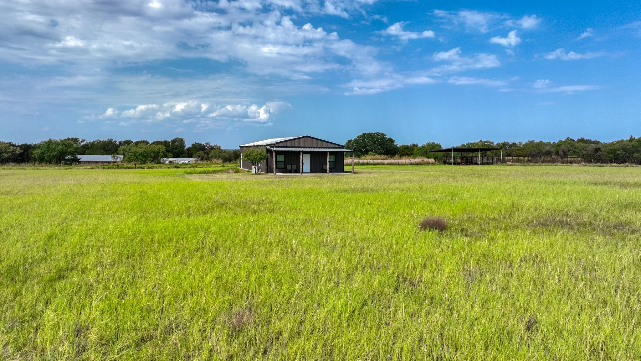 View of yard with a rural view and an outbuilding