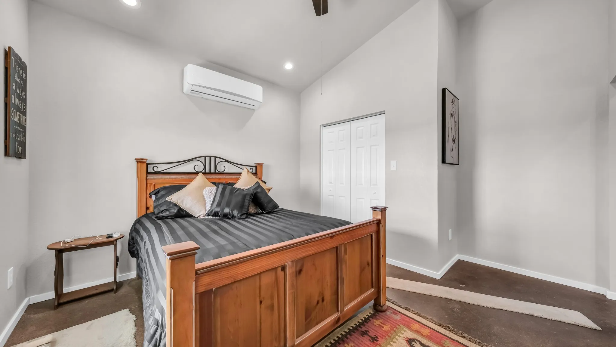 Bedroom with vaulted ceiling, recessed lighting, a closet, ceiling fan, and concrete flooring