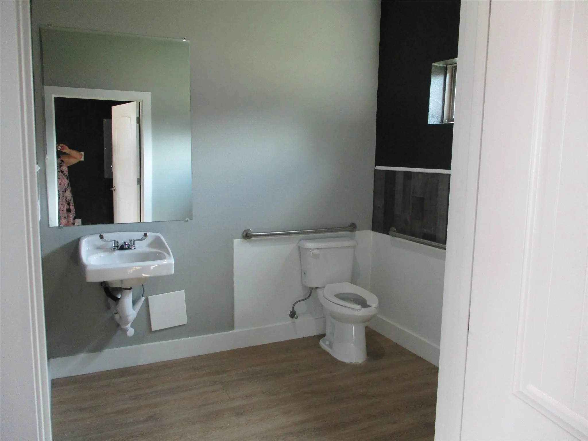 Bathroom featuring toilet and wood finished floors