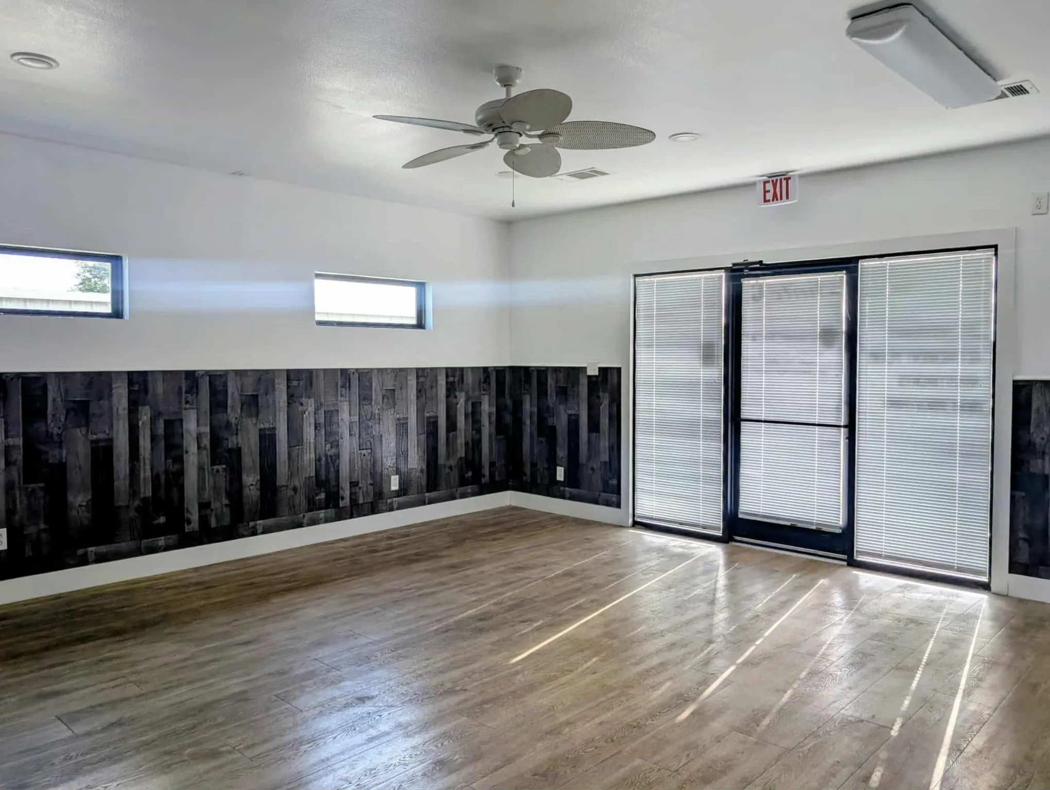 Unfurnished room with wood finished floors and a ceiling fan