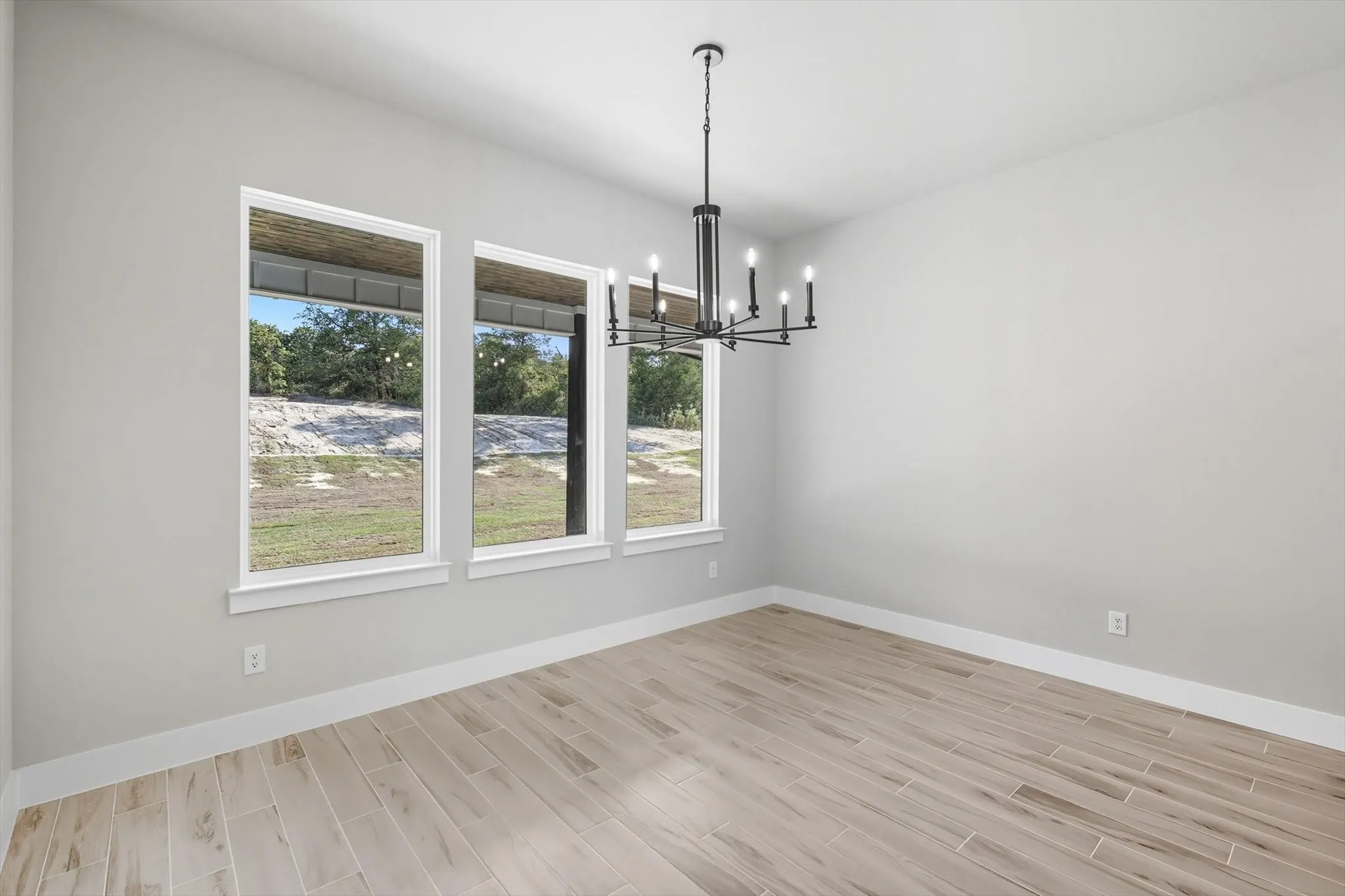 Unfurnished dining area featuring a chandelier and wood finish floors