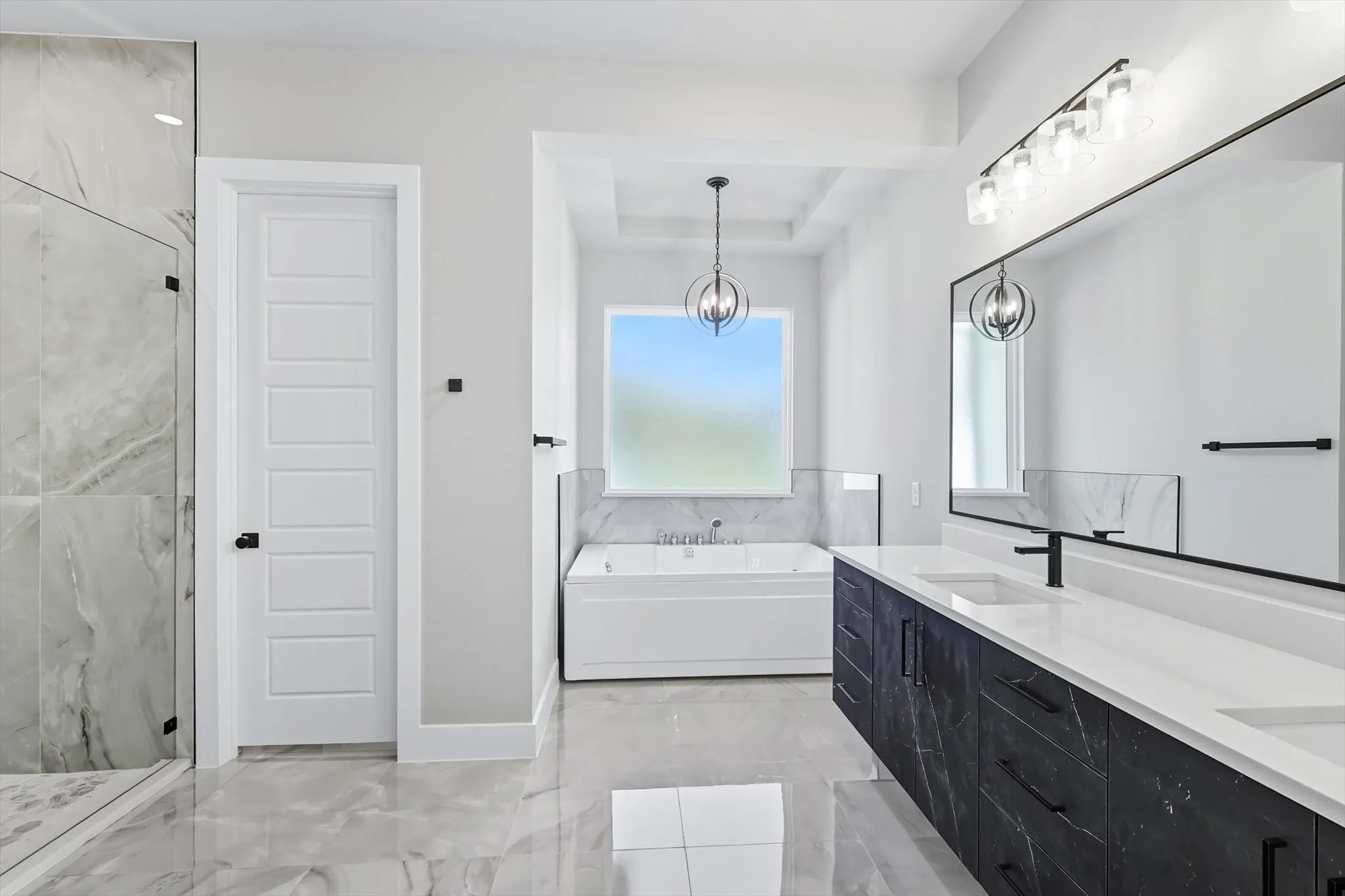 Bathroom with a bath, double vanity, a marble finish shower, and light marble finish floors