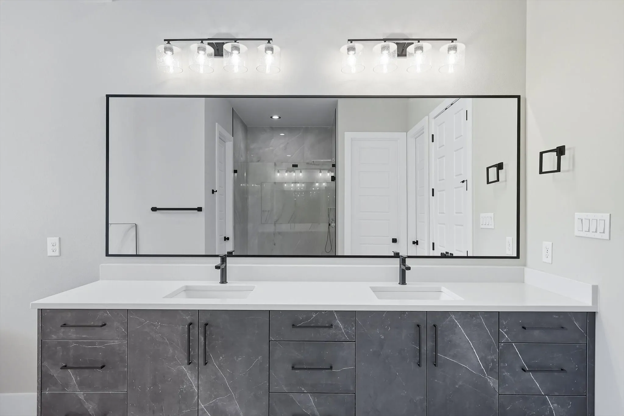 Full bathroom with a shower stall and double vanity