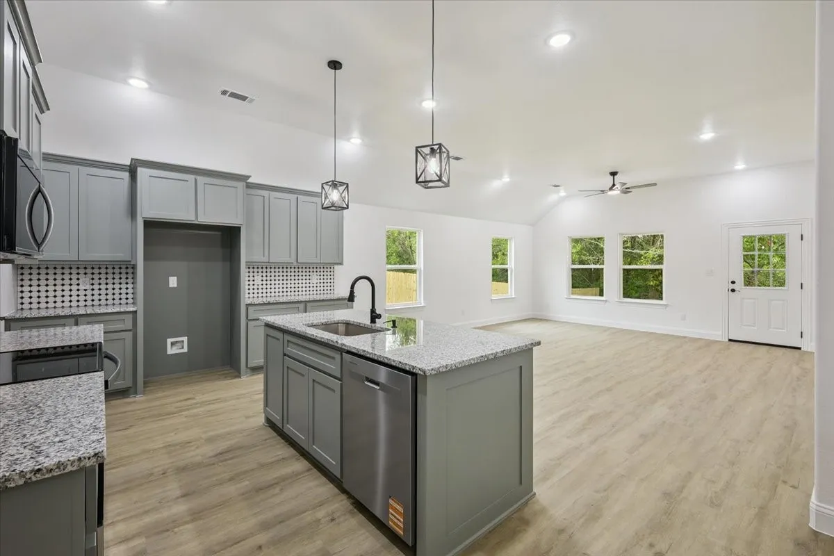 Kitchen featuring gray cabinets, backsplash, light wood-style flooring, dishwasher, and recessed lighting