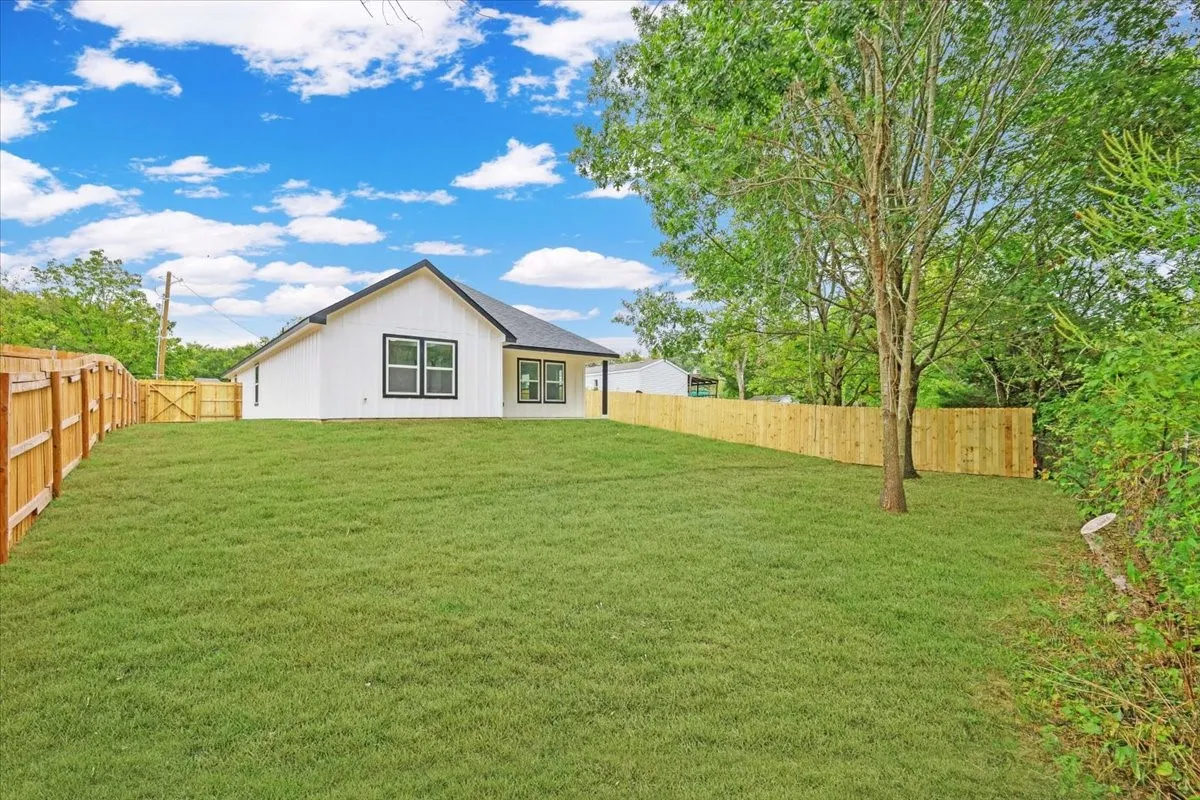 Back of property featuring a fenced backyard