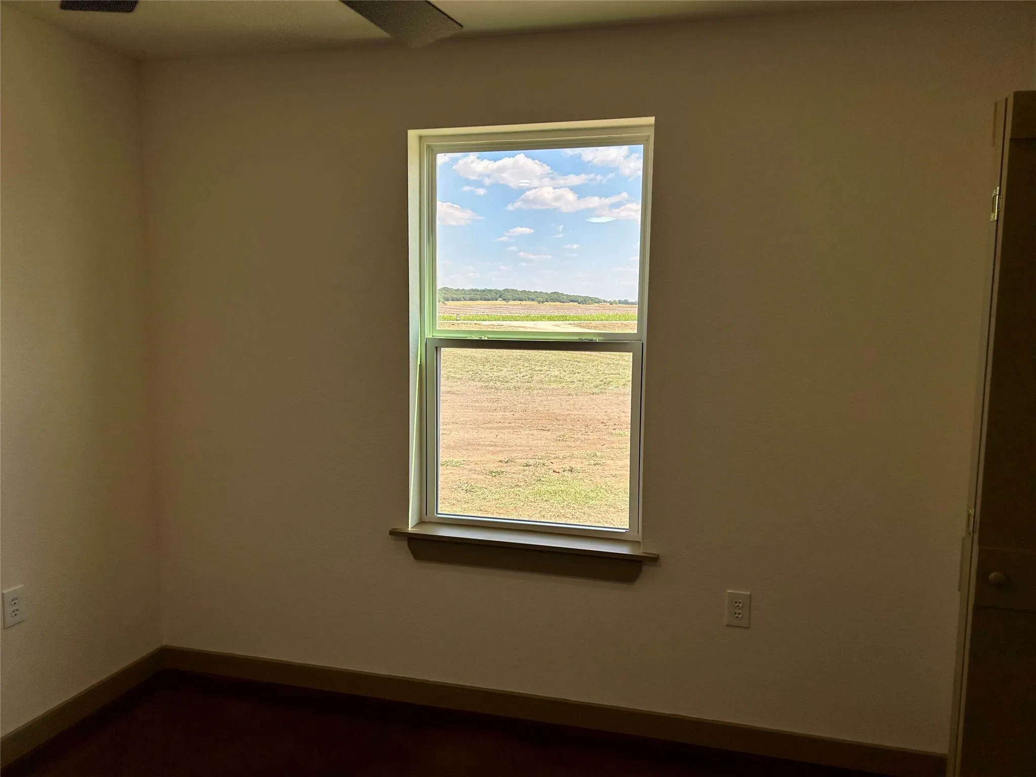 Spare room featuring healthy amount of natural light