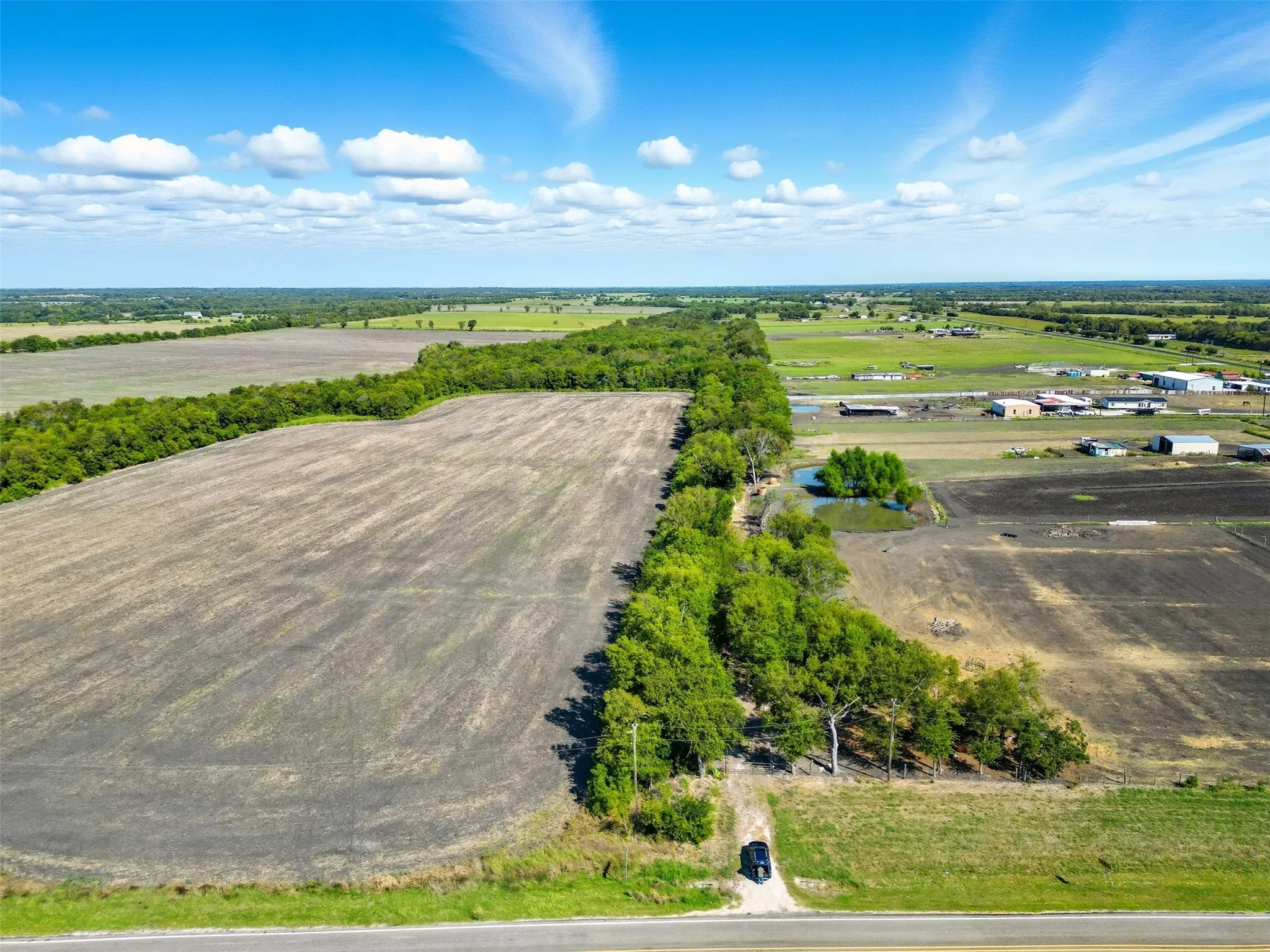 Overview of rural landscape featuring rows of crops