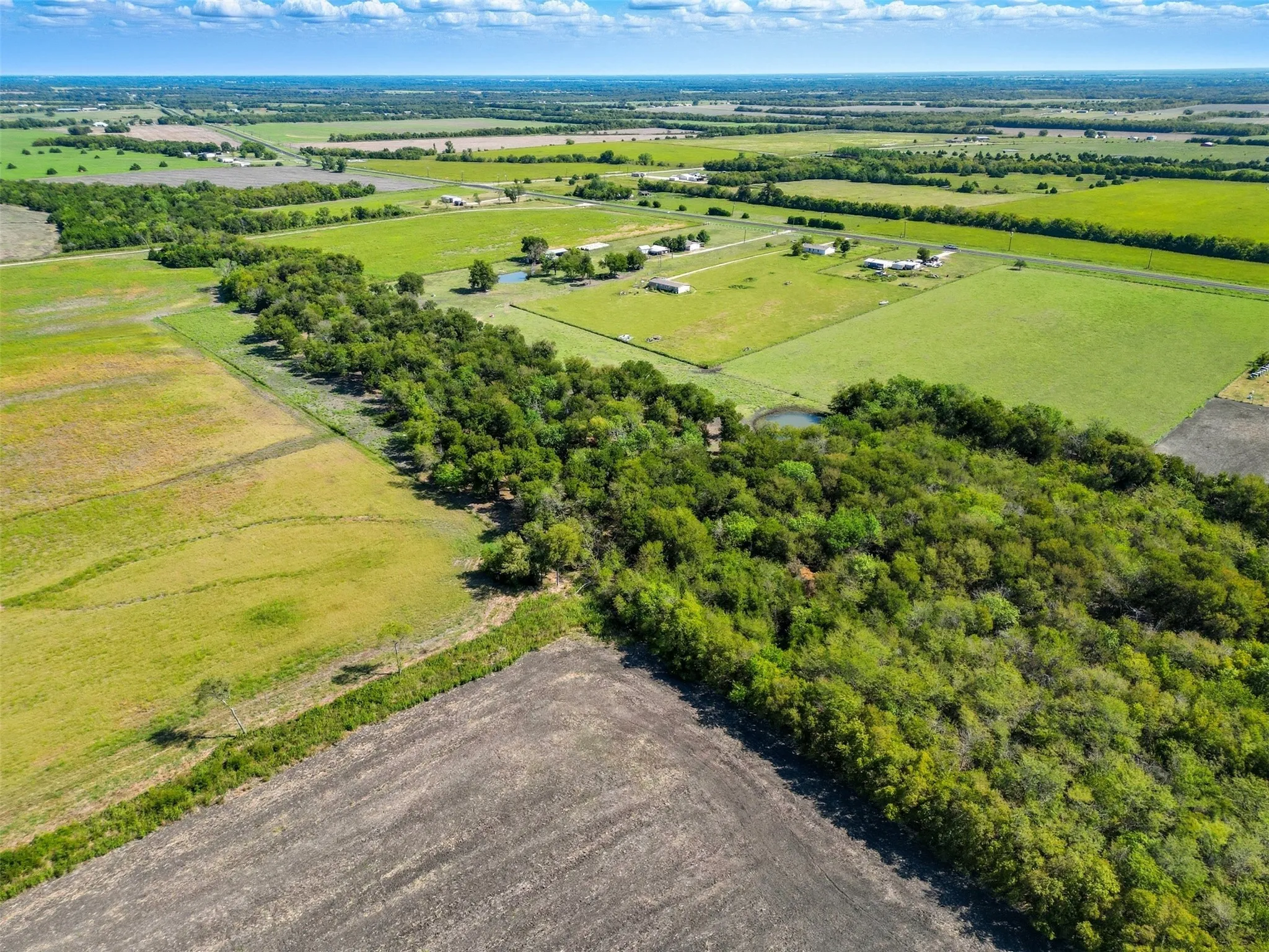Aerial view of sparsely populated area featuring farmland