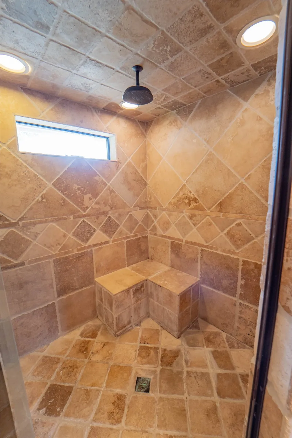 Custom tile shower with built in bench for ultimate relaxation.