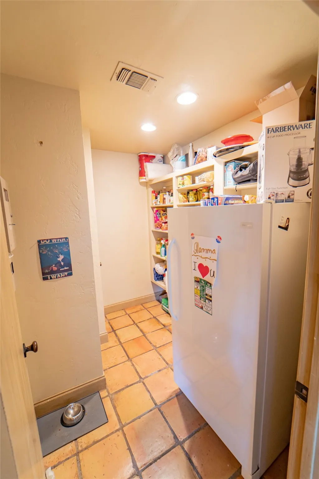 Full size pantry with built in shelving, located off of kitchen.