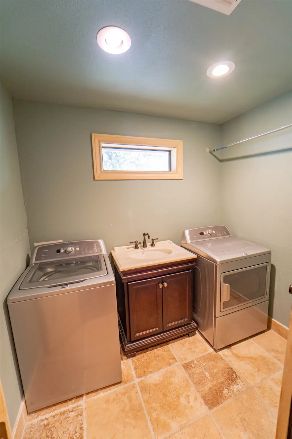 Full size laundry with lavatory and hanging option for convenience.