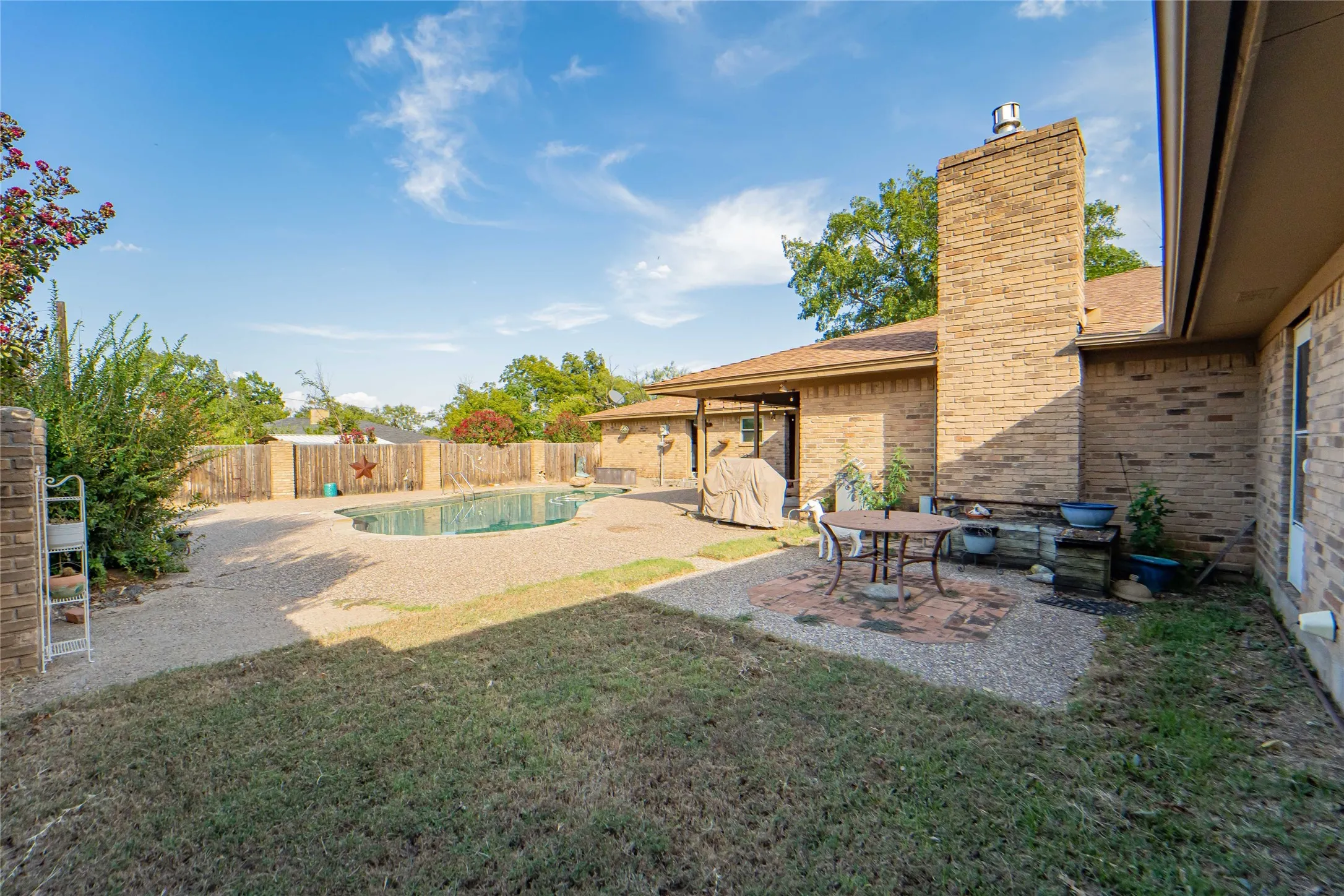 Private patio with pool views offers access to and from primary suite.