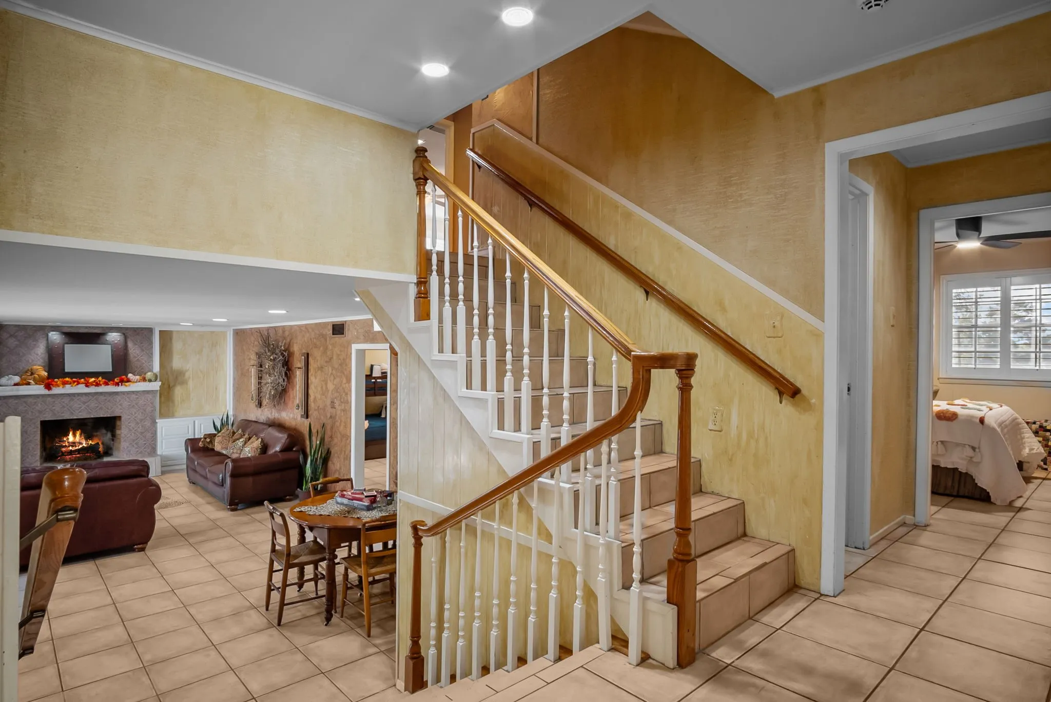 Large den with fireplace and exit to patio