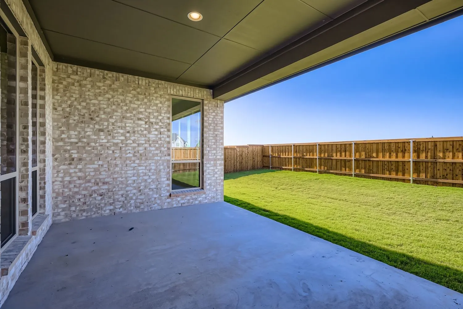 Fenced backyard featuring a patio