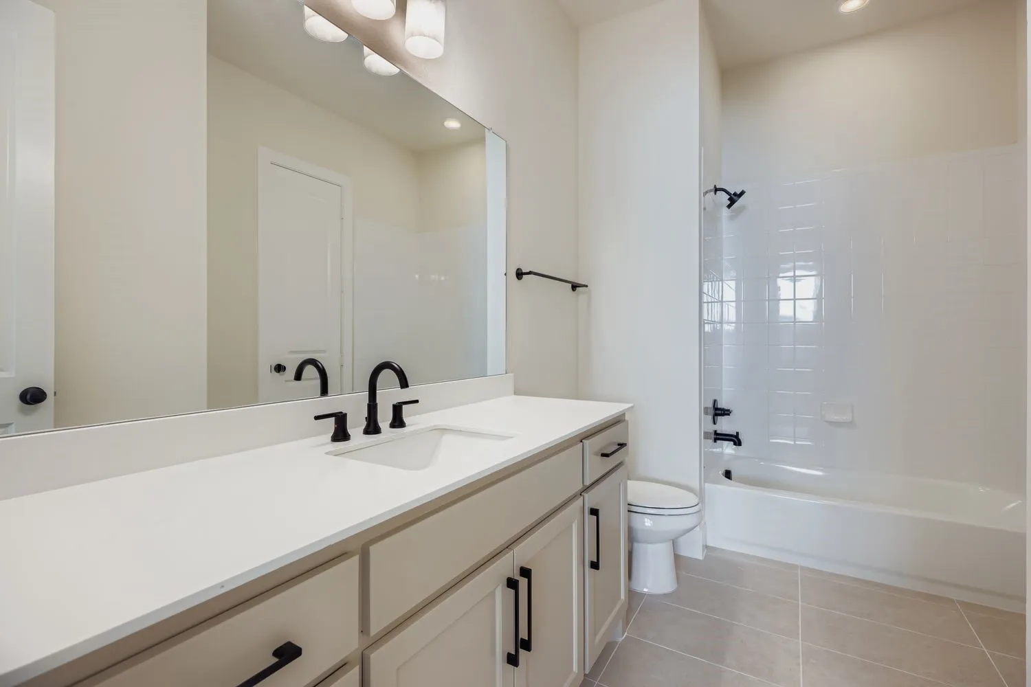 Bathroom with light tile patterned flooring, vanity, shower / bath combination, and recessed lighting