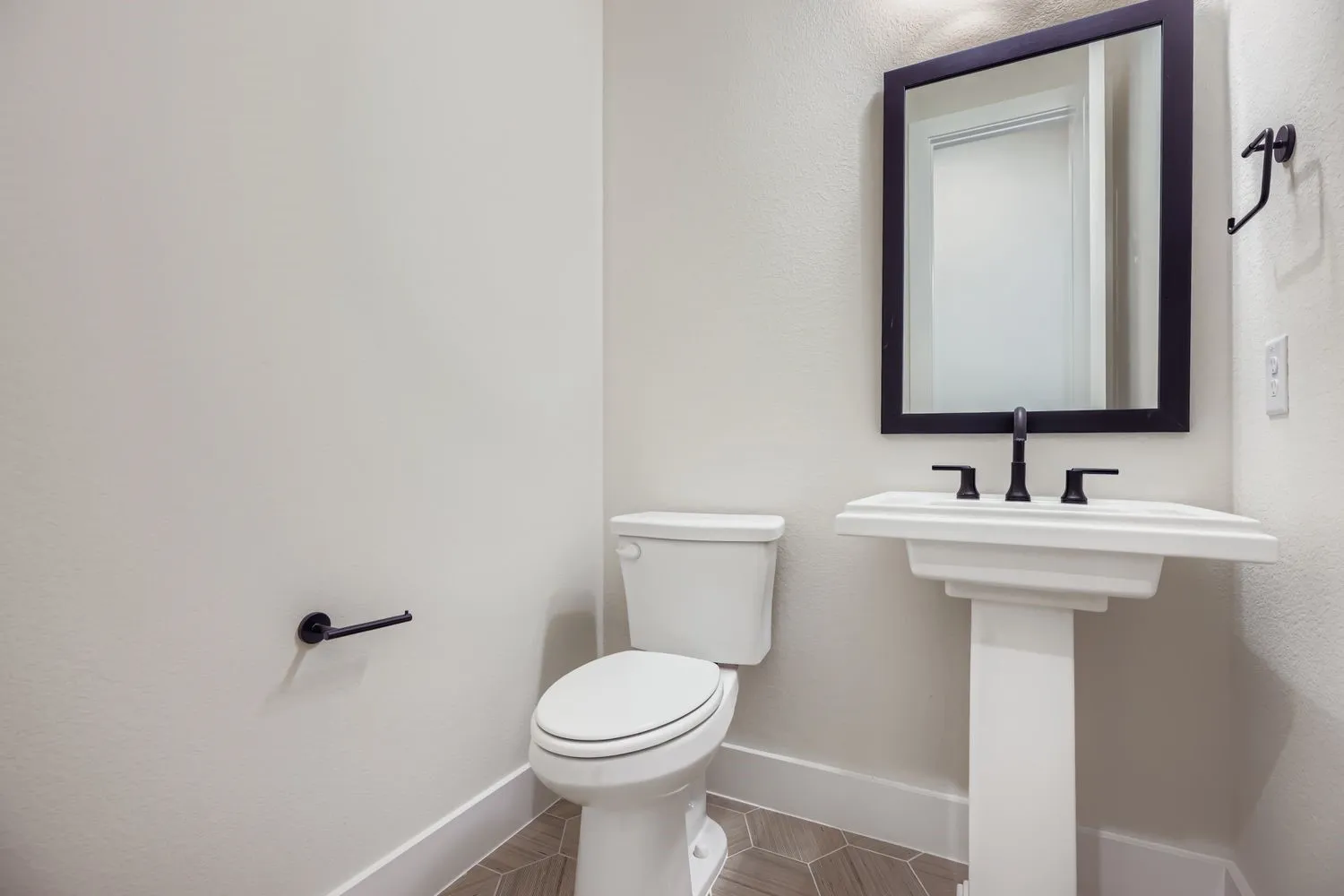Bathroom featuring baseboards and toilet