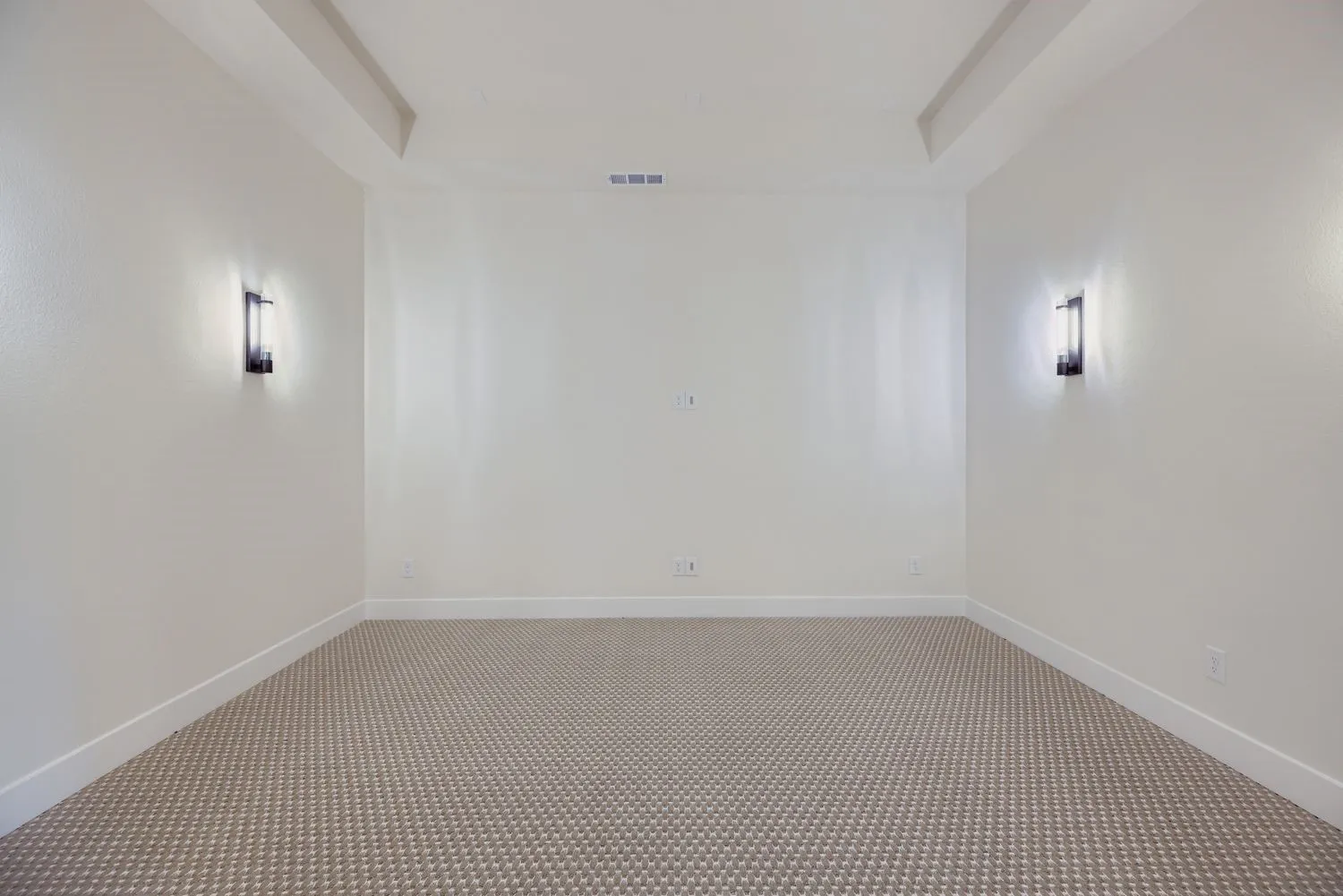 Empty room featuring carpet and baseboards