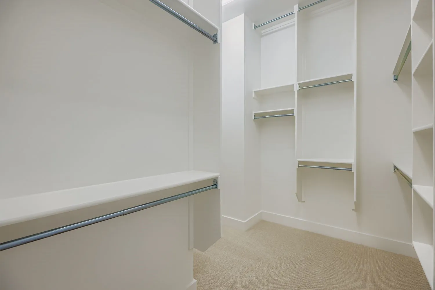 Spacious closet with light colored carpet
