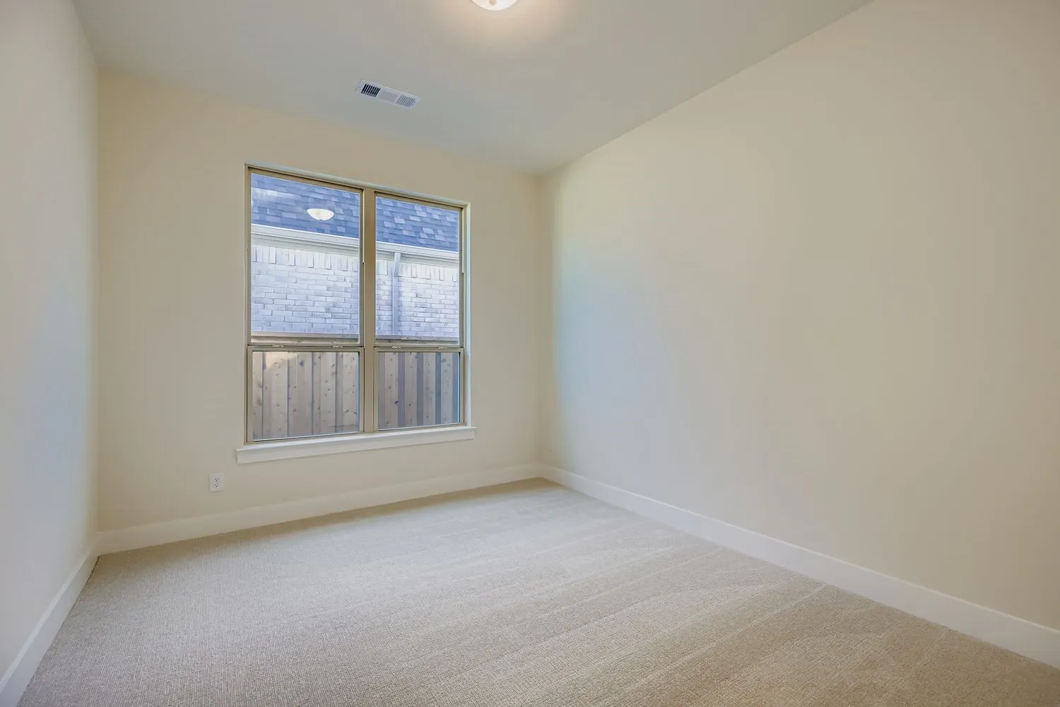 Unfurnished room featuring light colored carpet and baseboards
