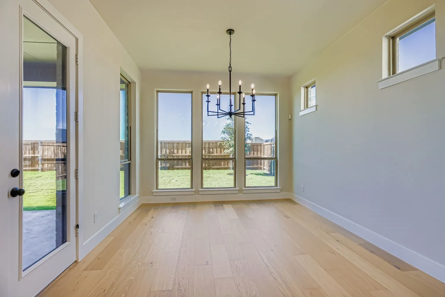Unfurnished dining area featuring a chandelier and light wood-style flooring