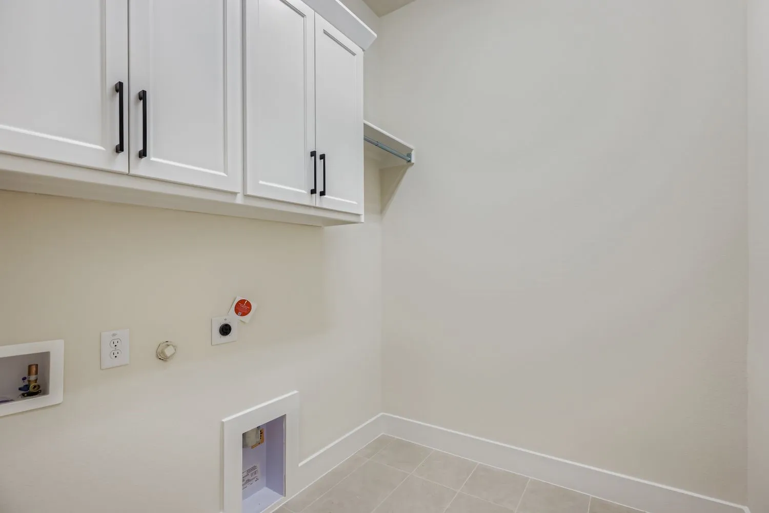 Laundry room featuring hookup for a gas dryer, light tile patterned floors, cabinet space, hookup for a washing machine, and hookup for an electric dryer