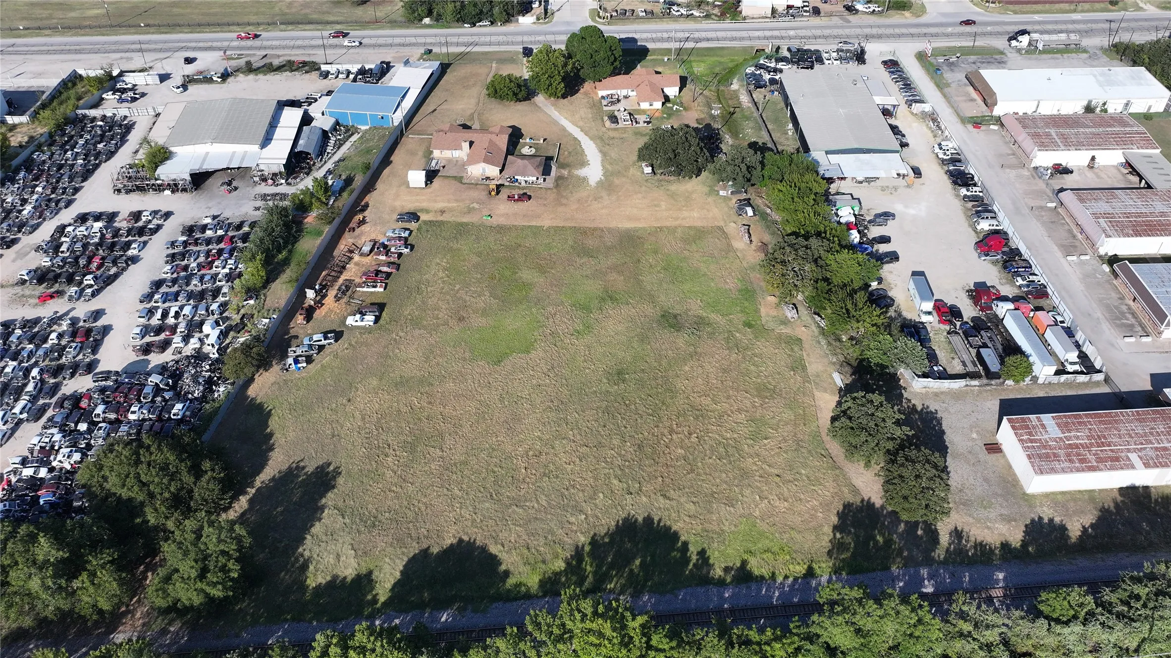 Aerial view of property and surrounding area with industrial structures