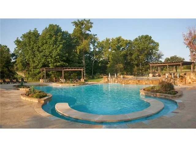 Community pool with a patio and a pergola