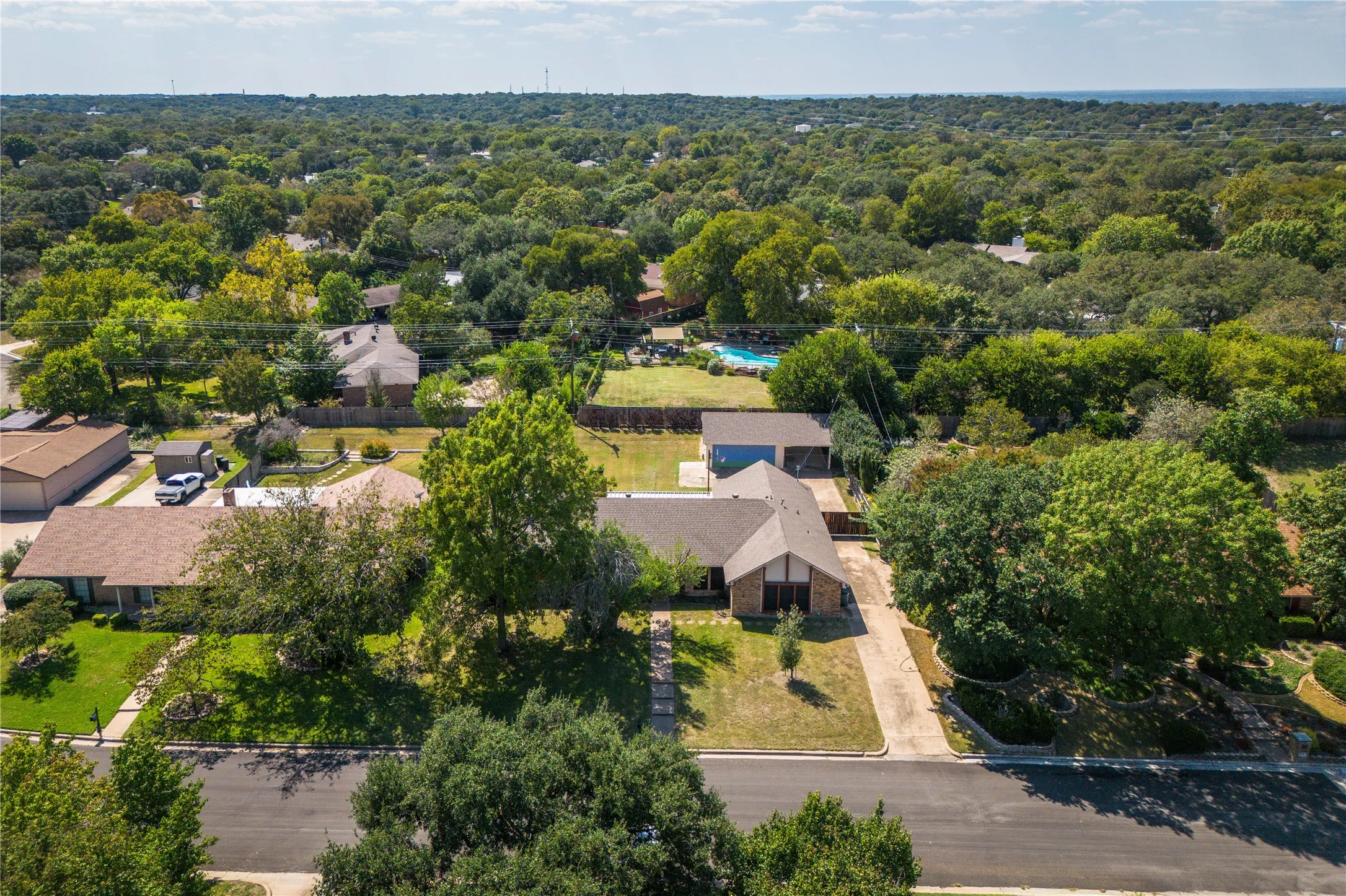 Aerial perspective of suburban area with a forest