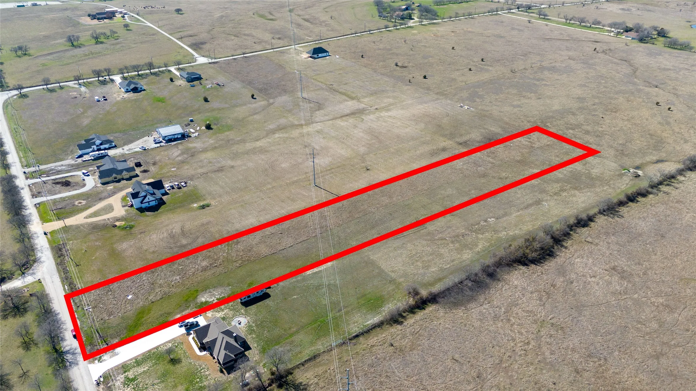 Aerial view of sparsely populated area with property boundaries highlighted