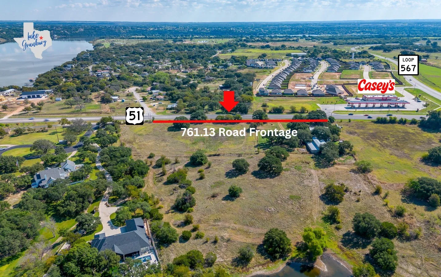 Aerial view of property and surrounding area with a large body of water