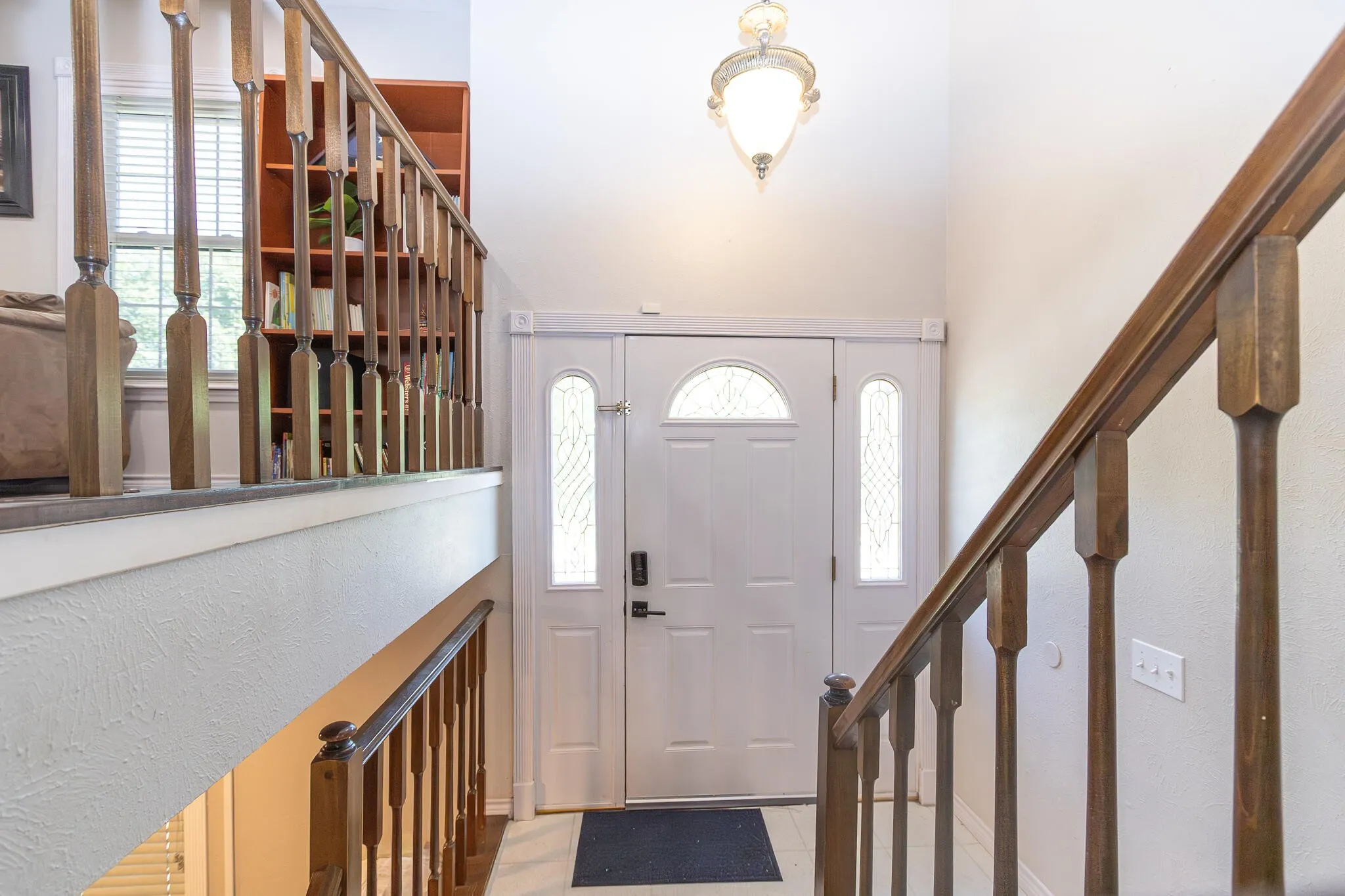 Foyer with stairs and light tile patterned floors