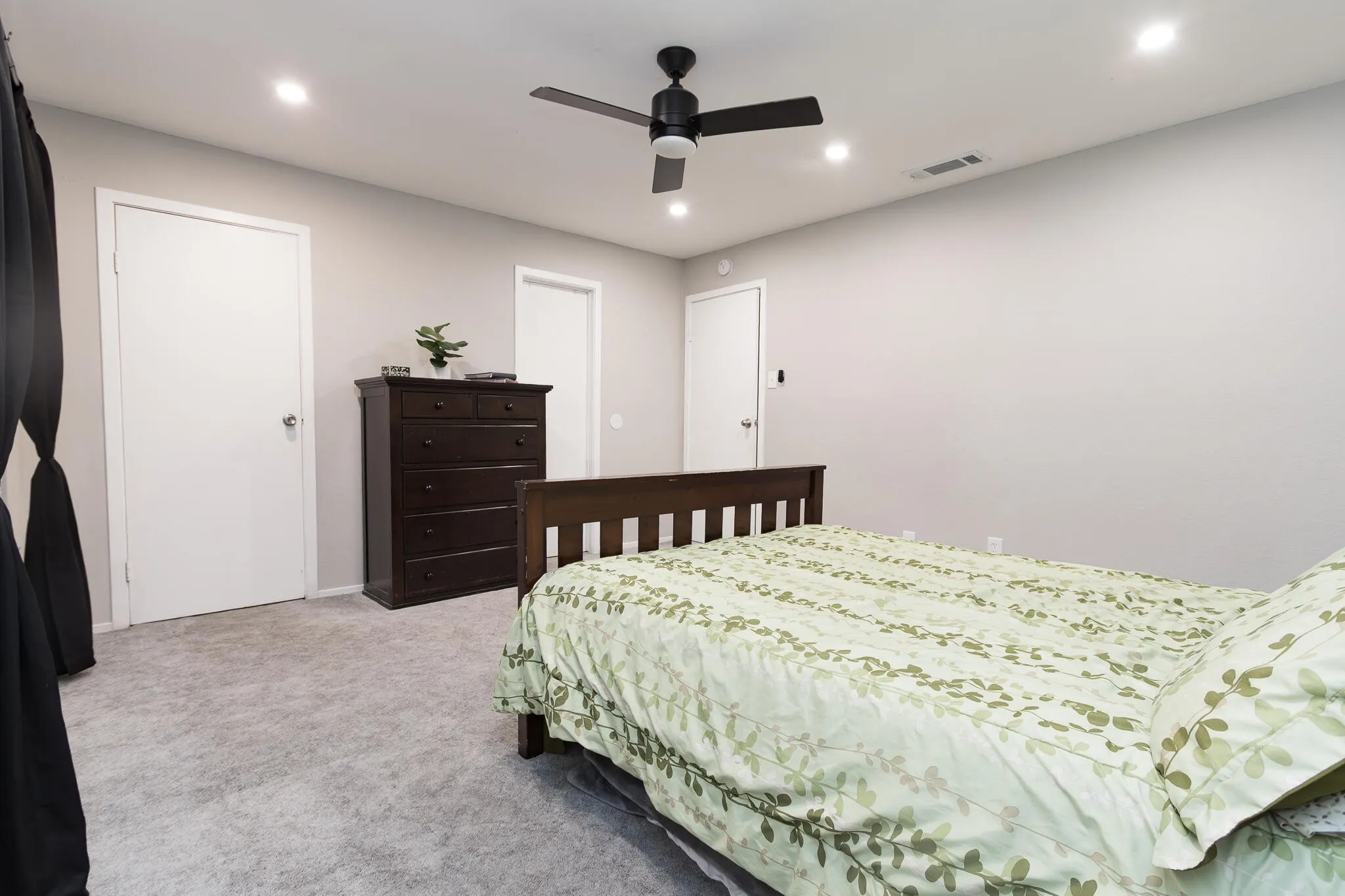 Bedroom featuring light colored carpet, recessed lighting, and a ceiling fan