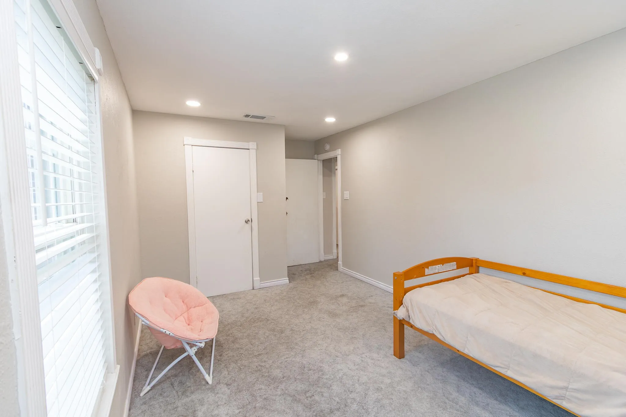 Carpeted bedroom featuring recessed lighting and a closet