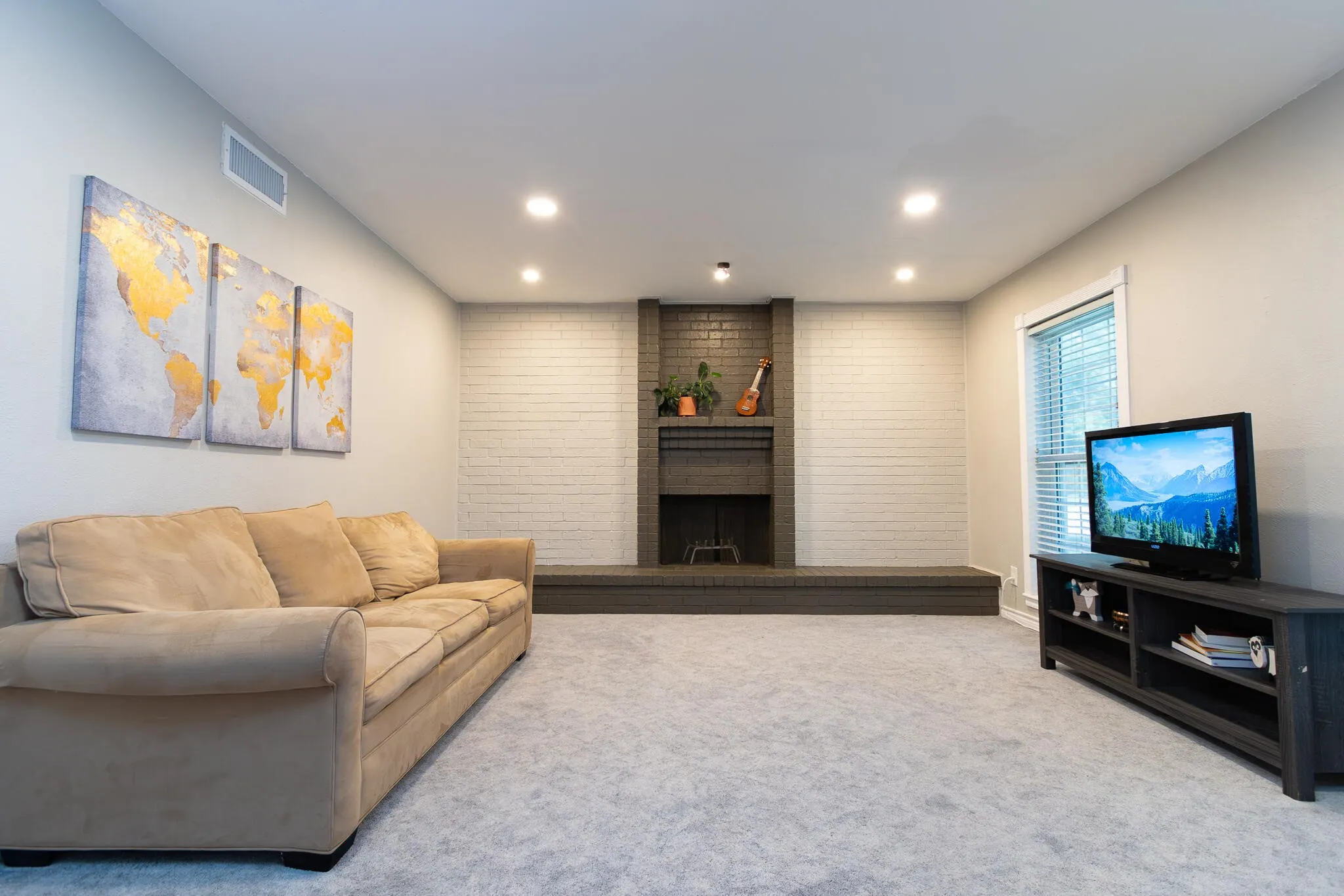 Carpeted living room featuring a fireplace and recessed lighting