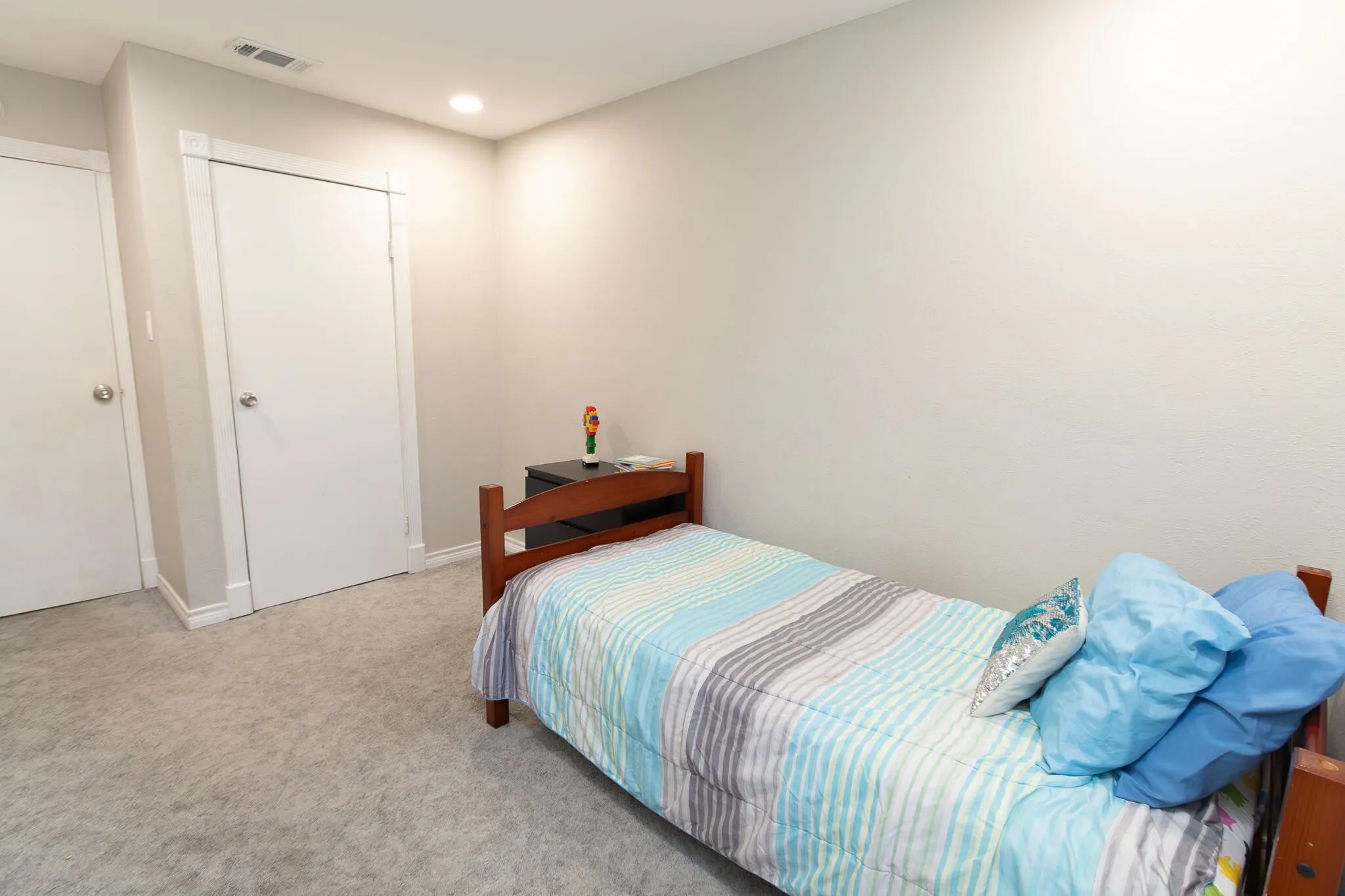Carpeted bedroom with baseboards and recessed lighting